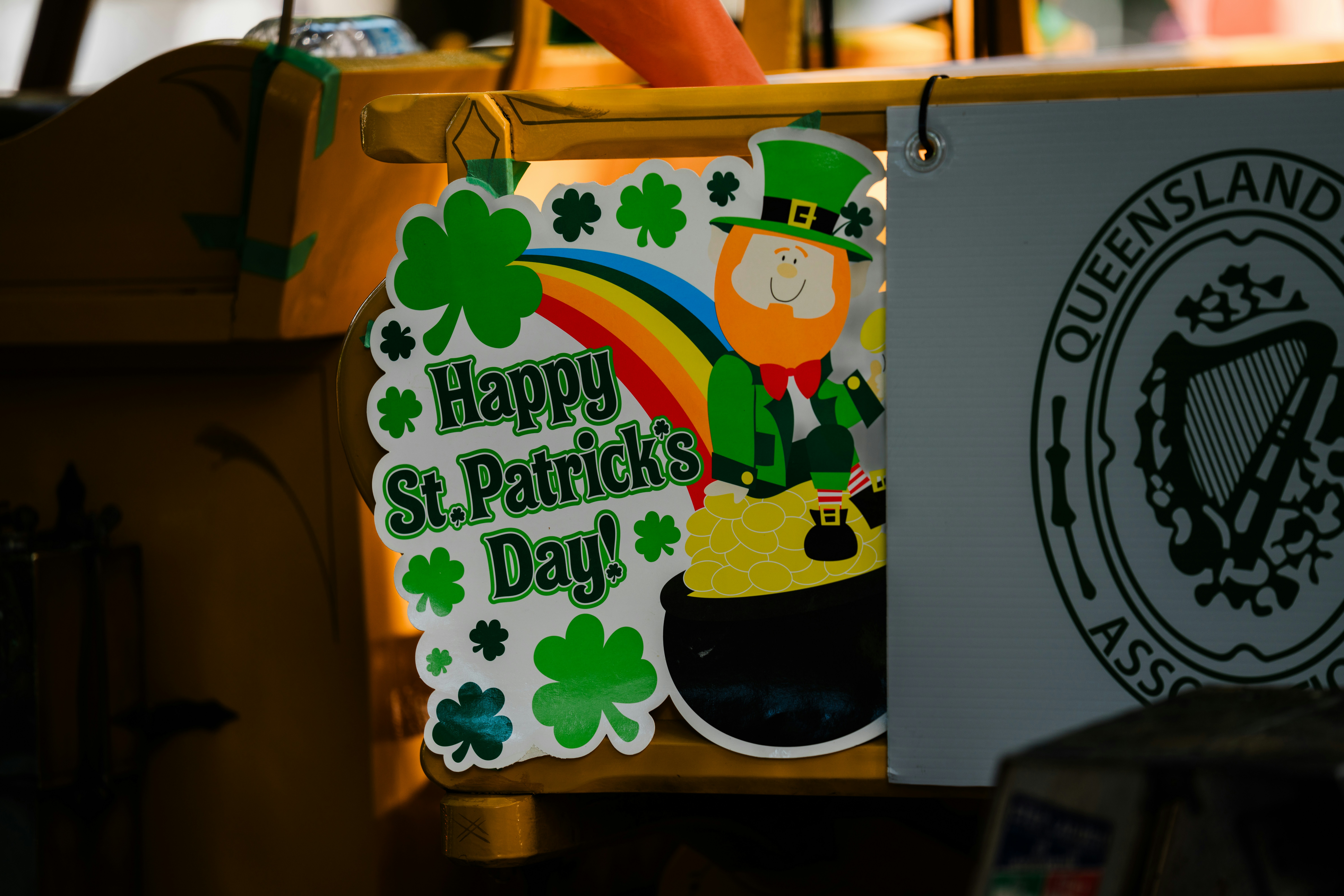 Happy st. patrick's day sign with leprechaun and rainbow.