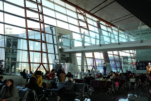 Airport terminal with travelers waiting at gates