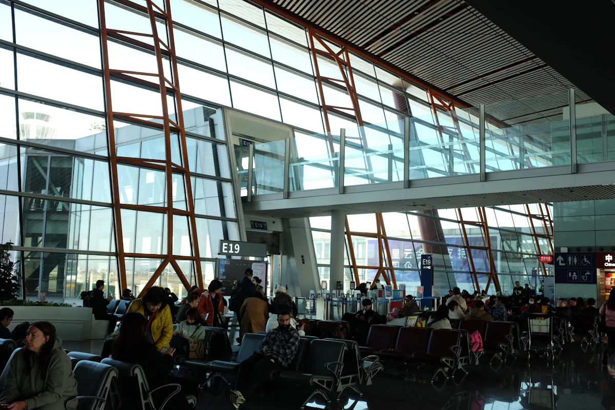 Travelers waiting at gates in a bright airport terminal