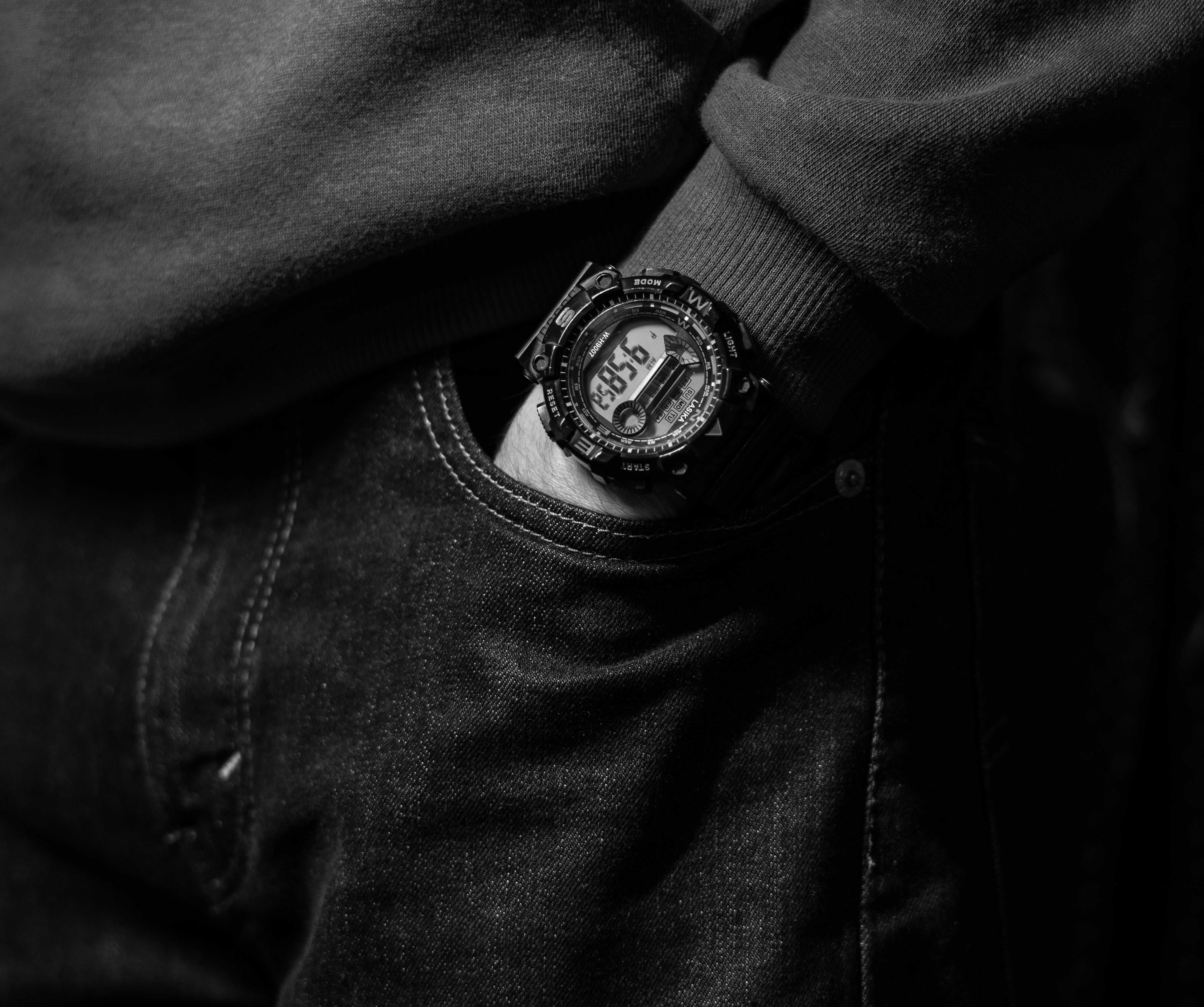 A Digital Wristwatch On Their Left Arm.