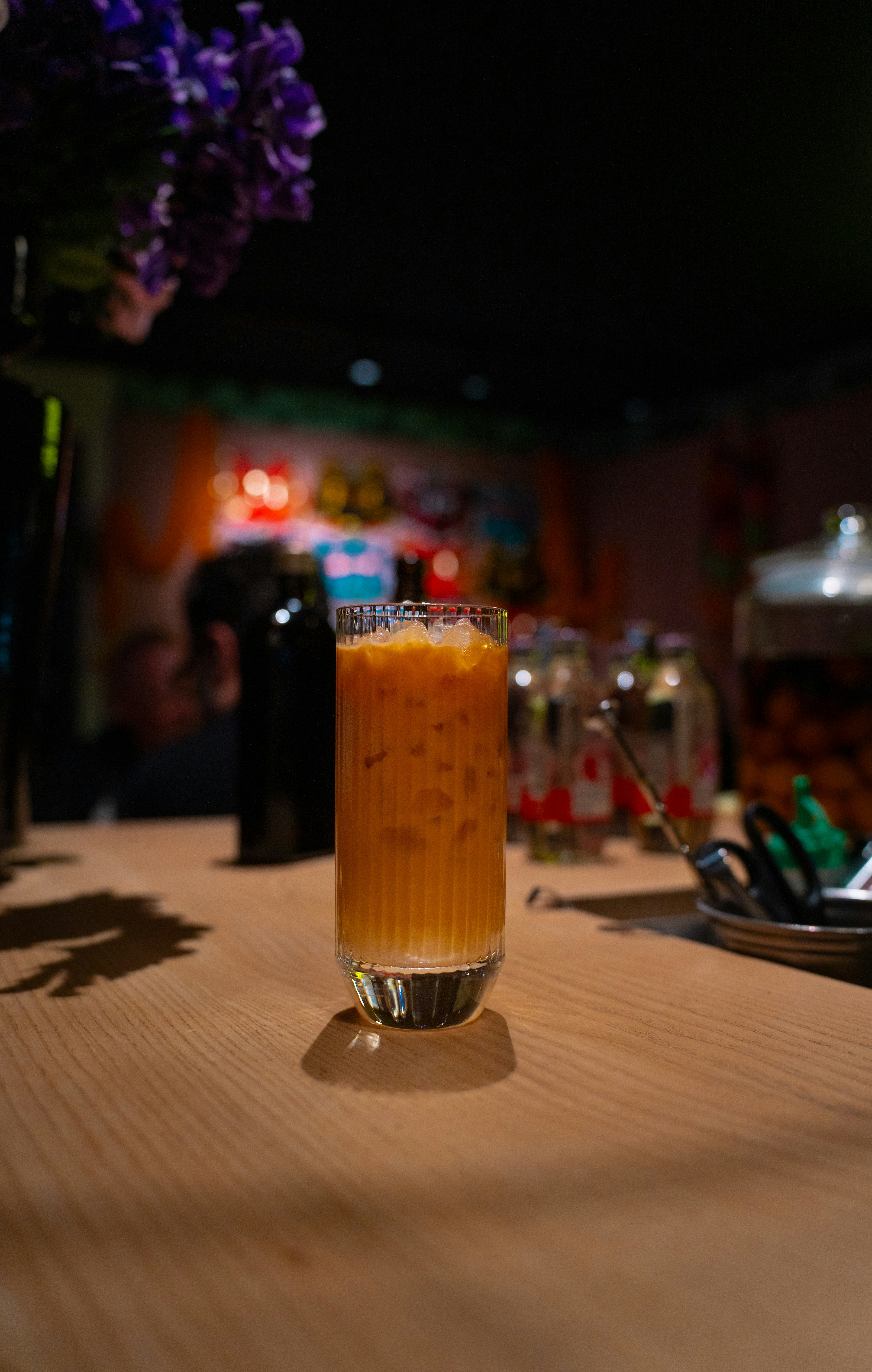 A tall glass of iced tea with ice cubes.