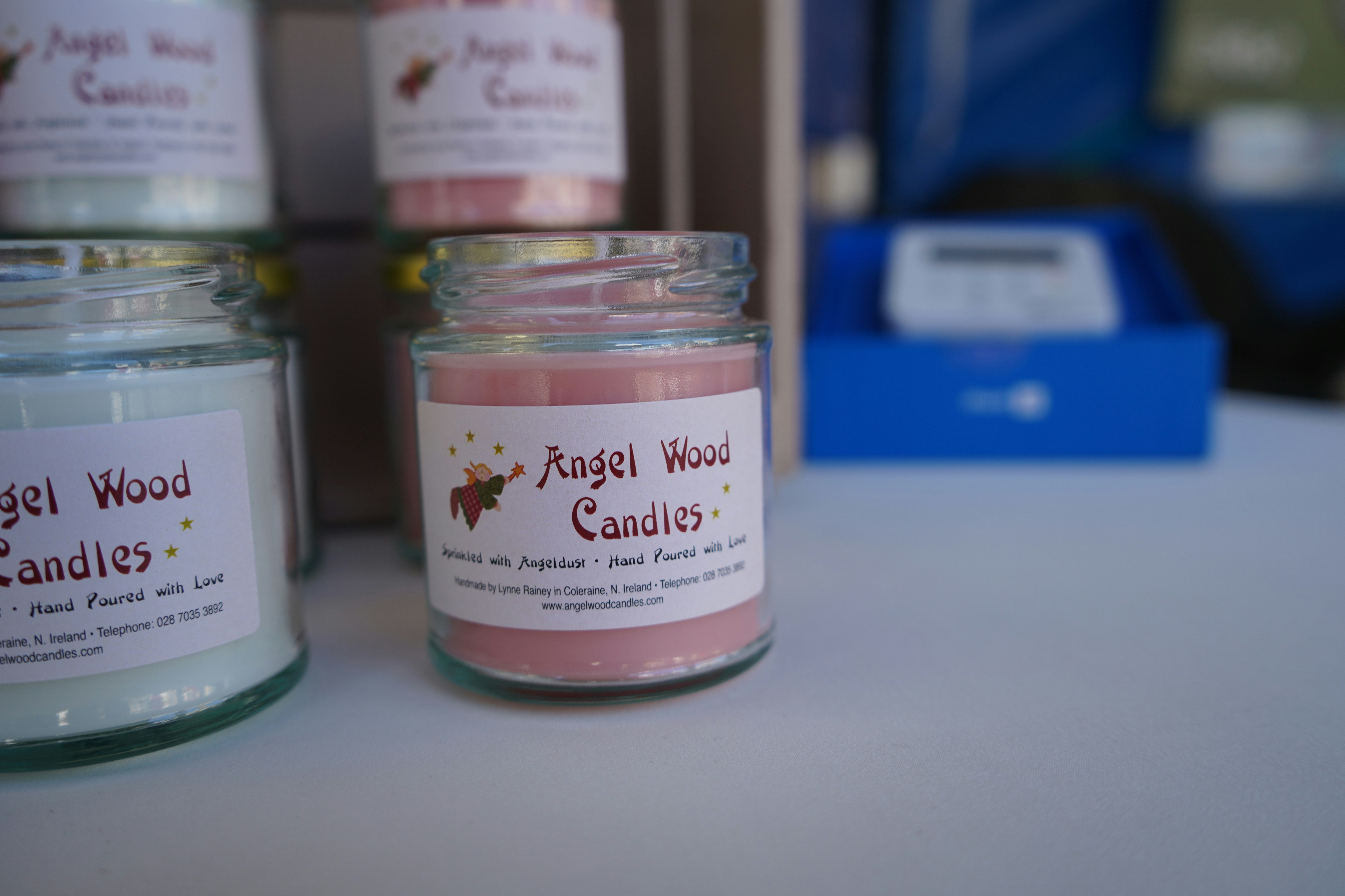 Small glass jars with pink and blue scented candles