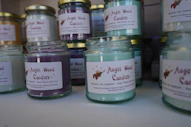 Jars of colorful scented candles on a shelf