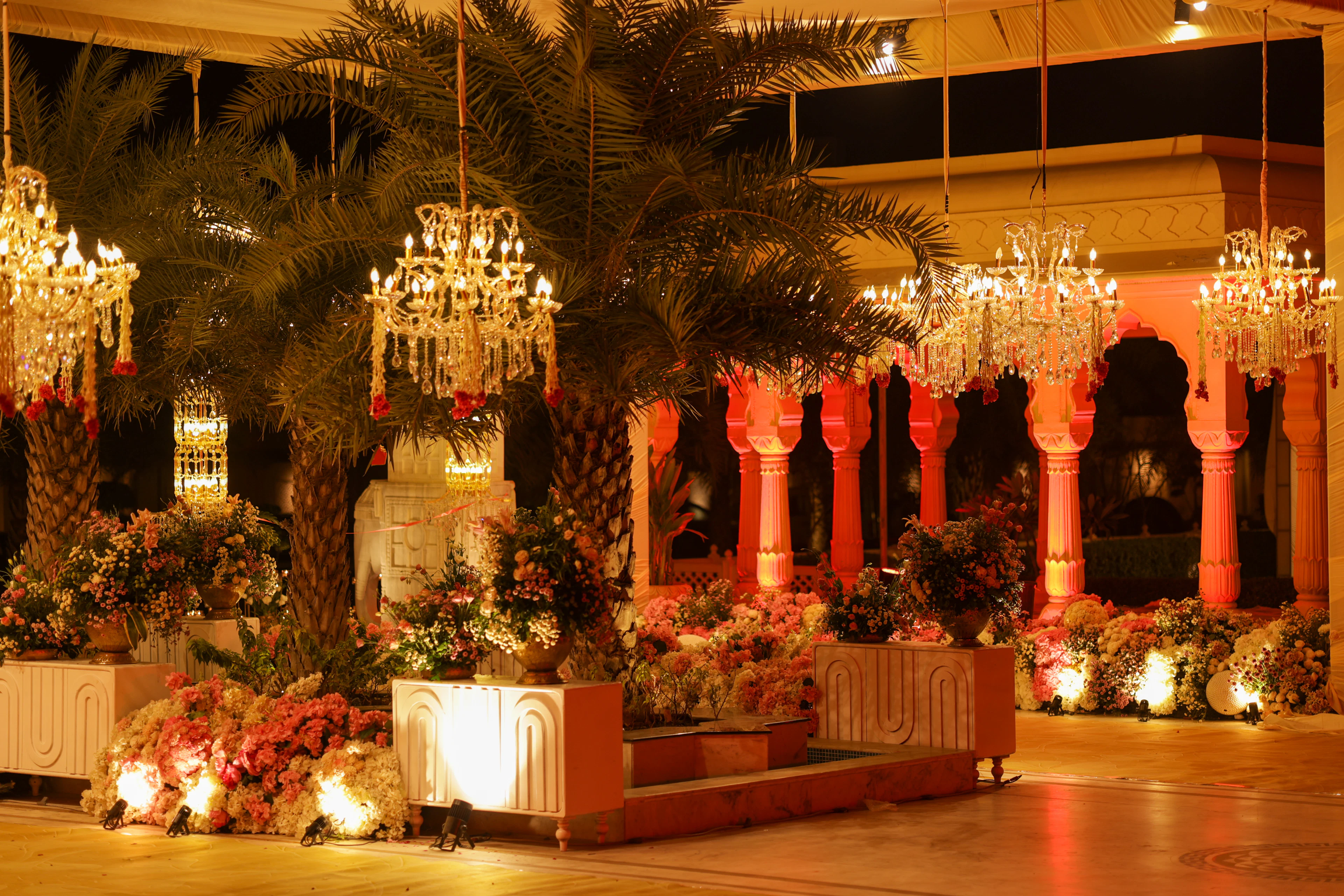 Elegant event venue with chandeliers and floral arrangements