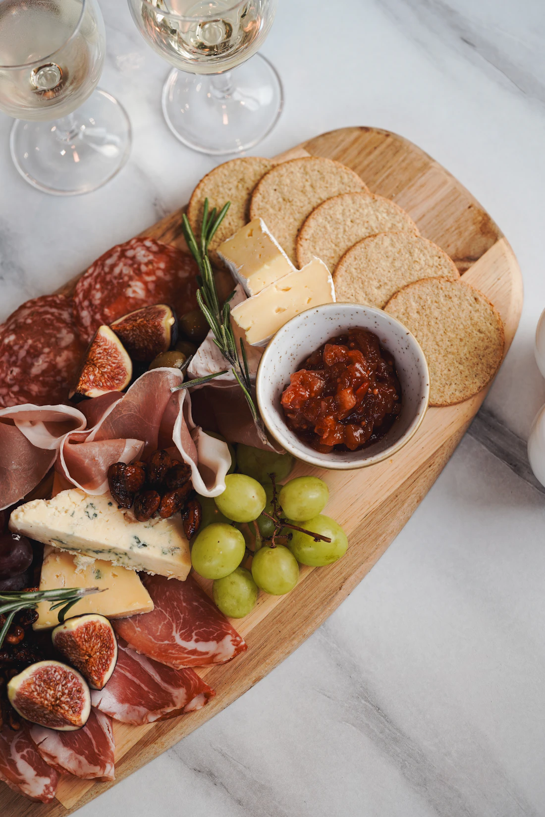 A grazing board with cheeses, cured meats and fruit