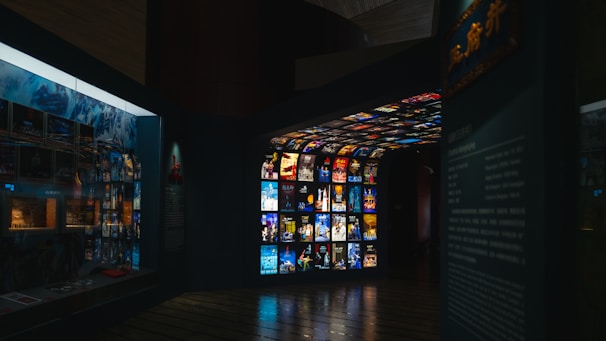 Museum exhibit with screens displaying various media