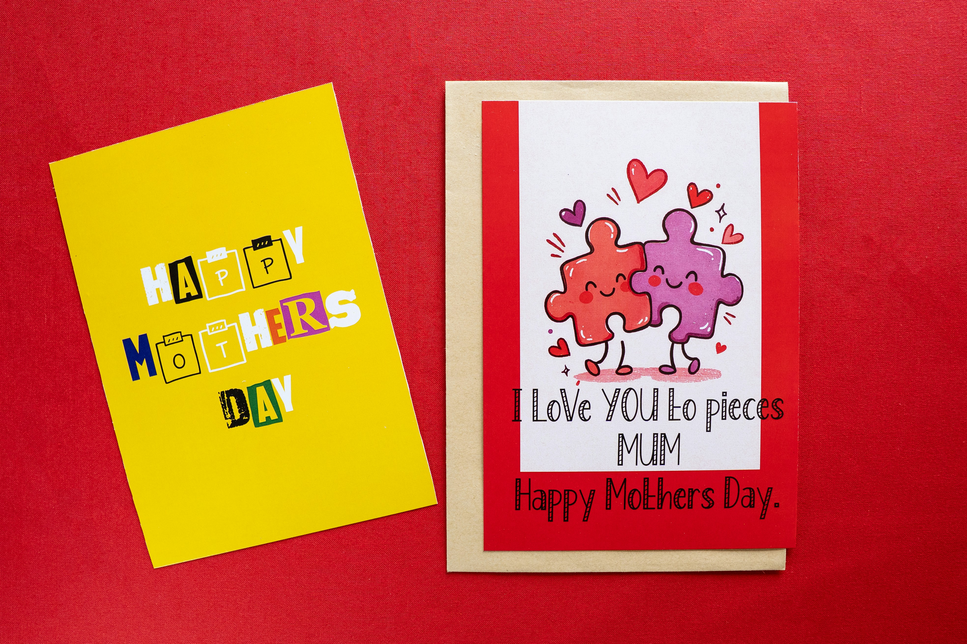 Two mother's day cards with puzzle pieces and hearts