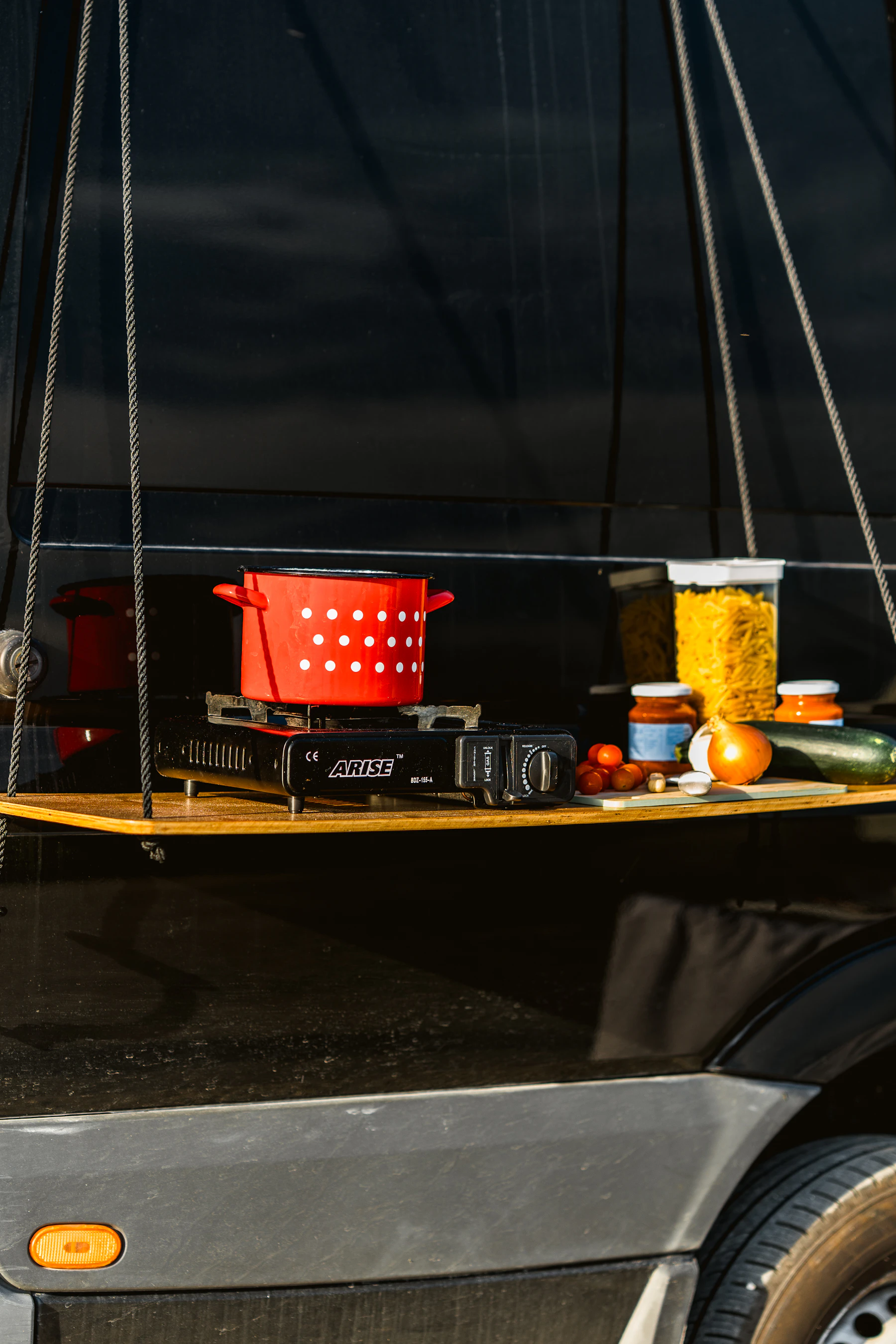 Organized portable camp kitchen with cookware and food preparation equipment