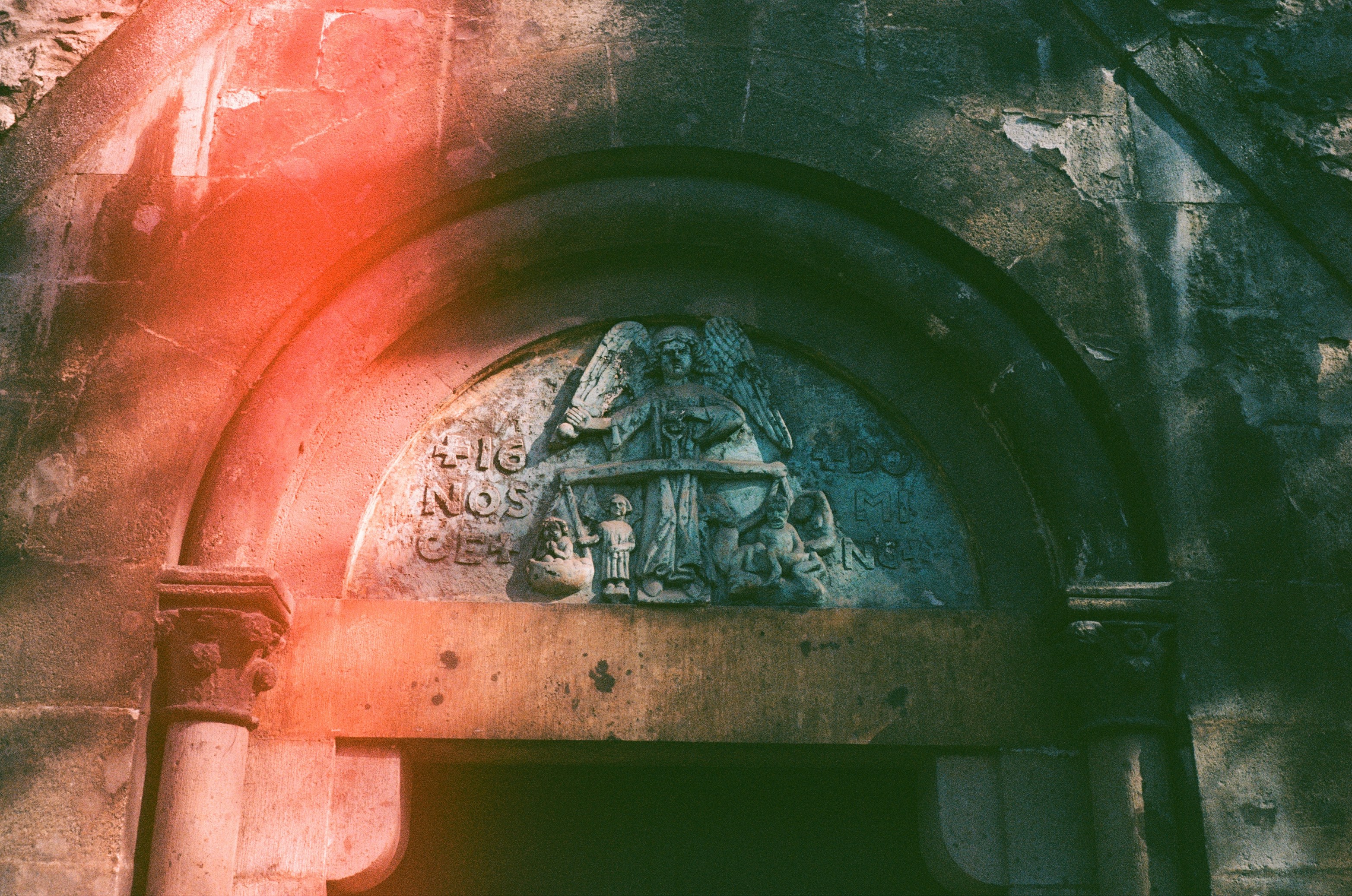 Arched doorway with ancient stone carving