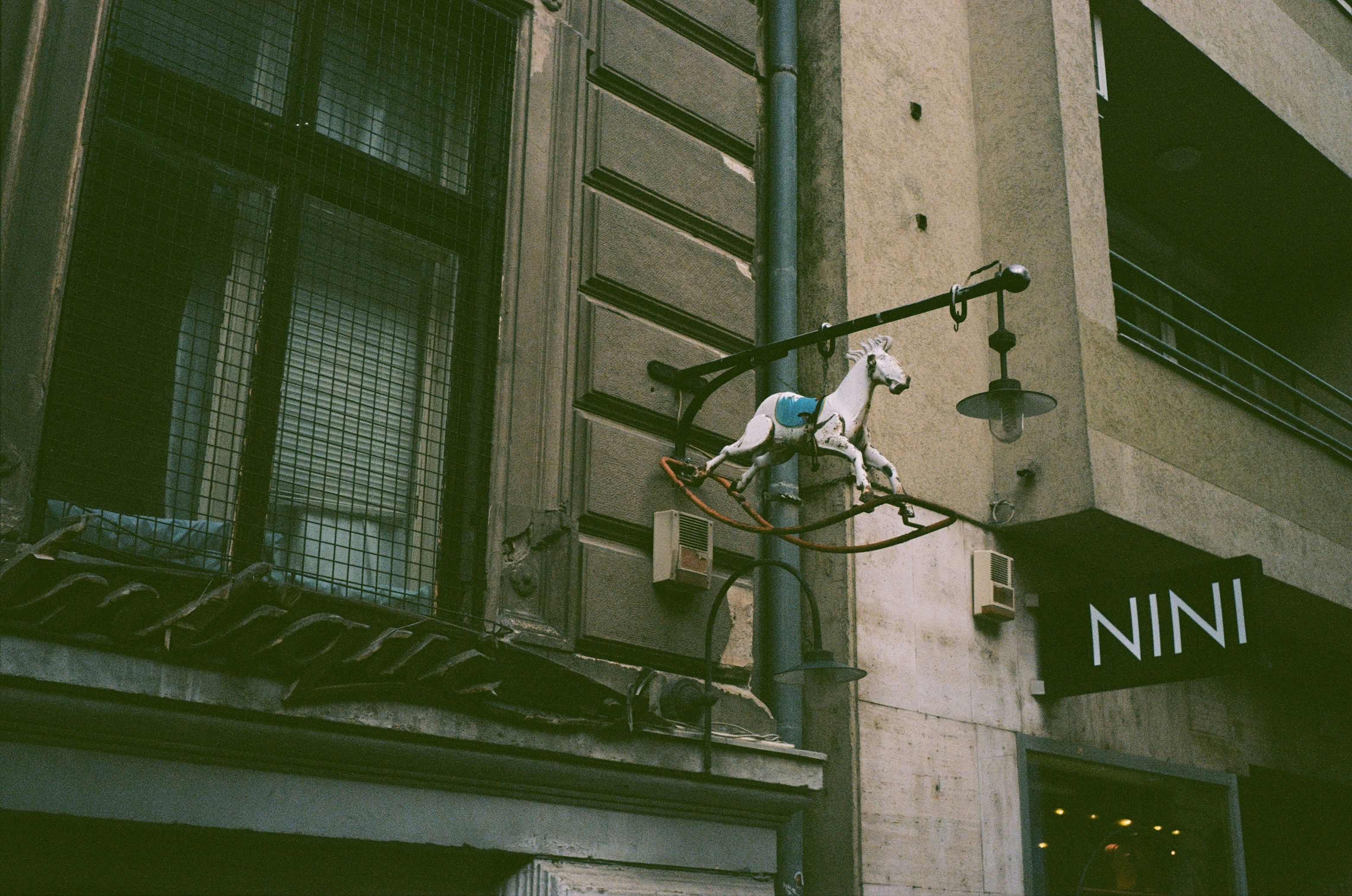 Rocking horse sign hangs outside a building