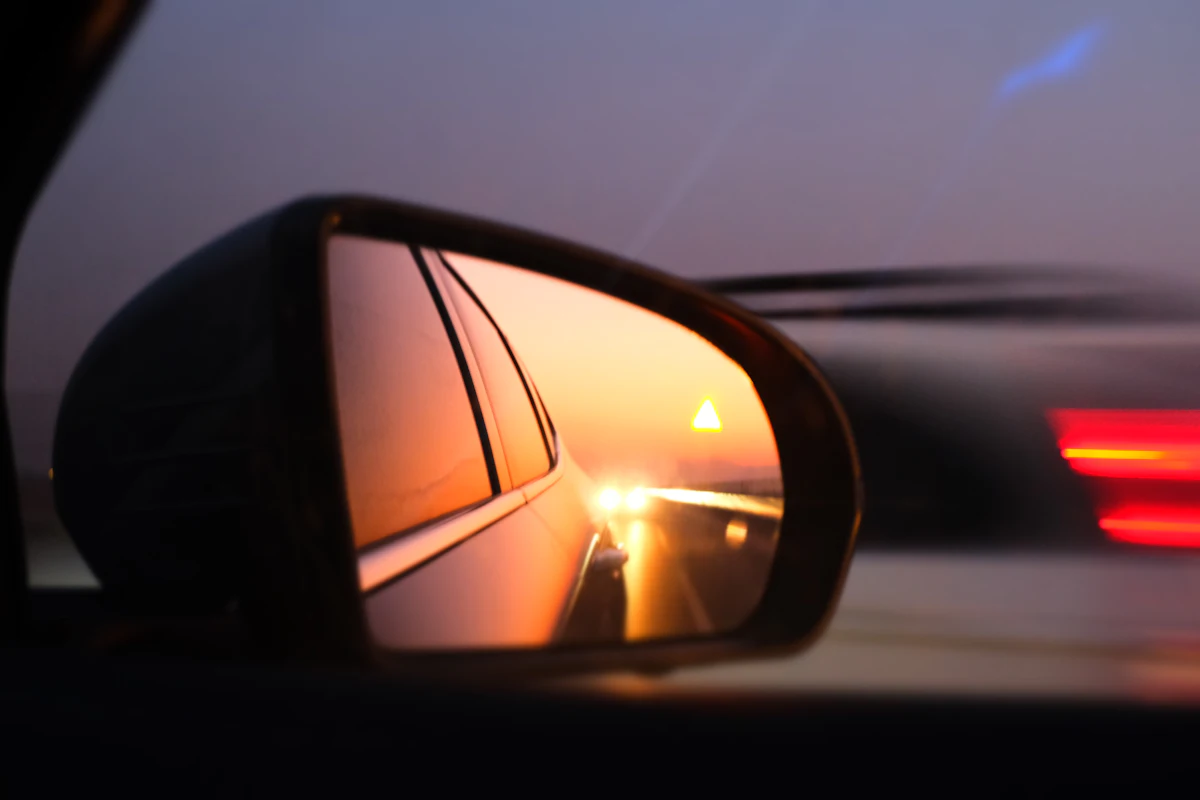 A car passing alongside, seen in a side mirror