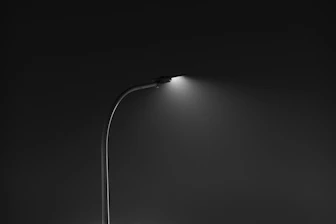 A solitary street lamp illuminates the dark night.