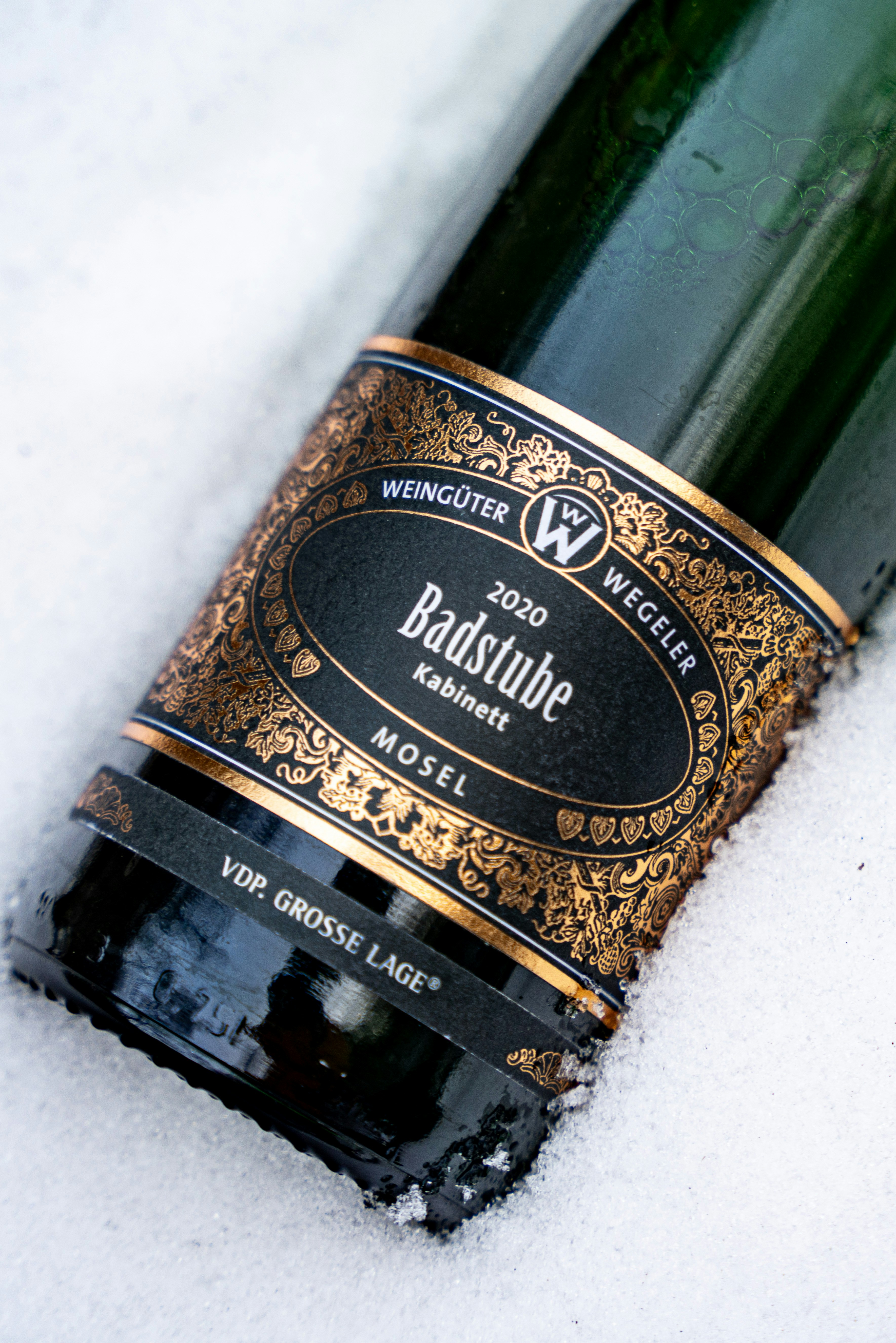 A bottle of badstube mosel wine in snow