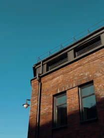 Brick building with windows against a clear blue sky