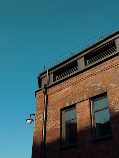 Brick building with windows against a clear blue sky