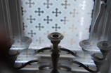 Ornate candelabra in front of a patterned window