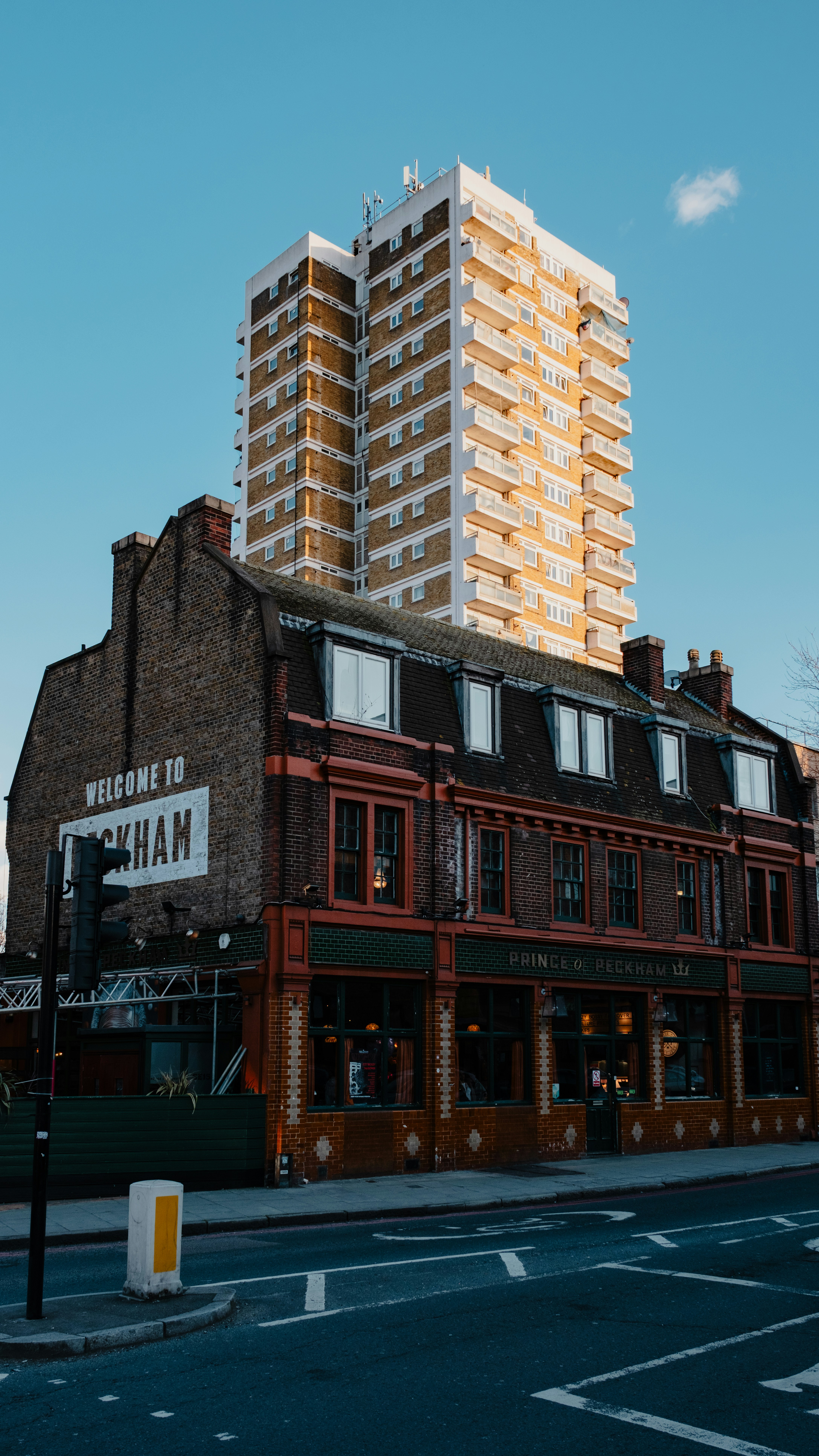 Tall apartment building behind brick pub