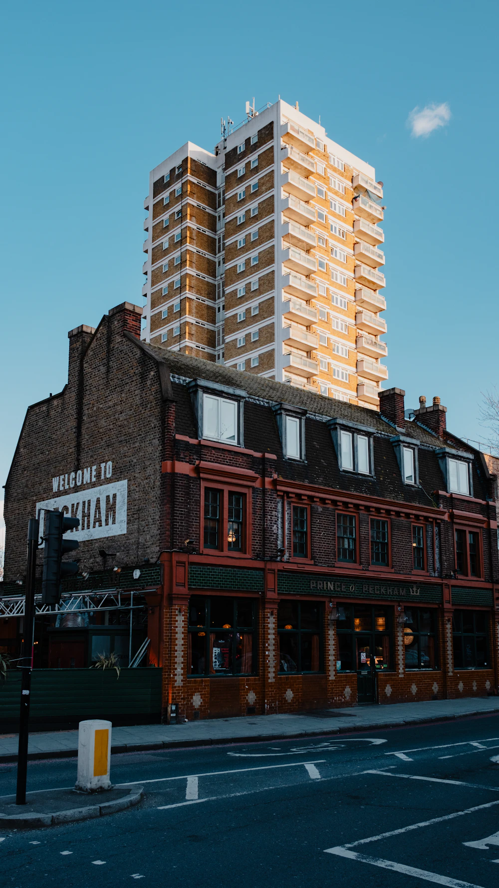 A lively Peckham street scene with colourful evening light
