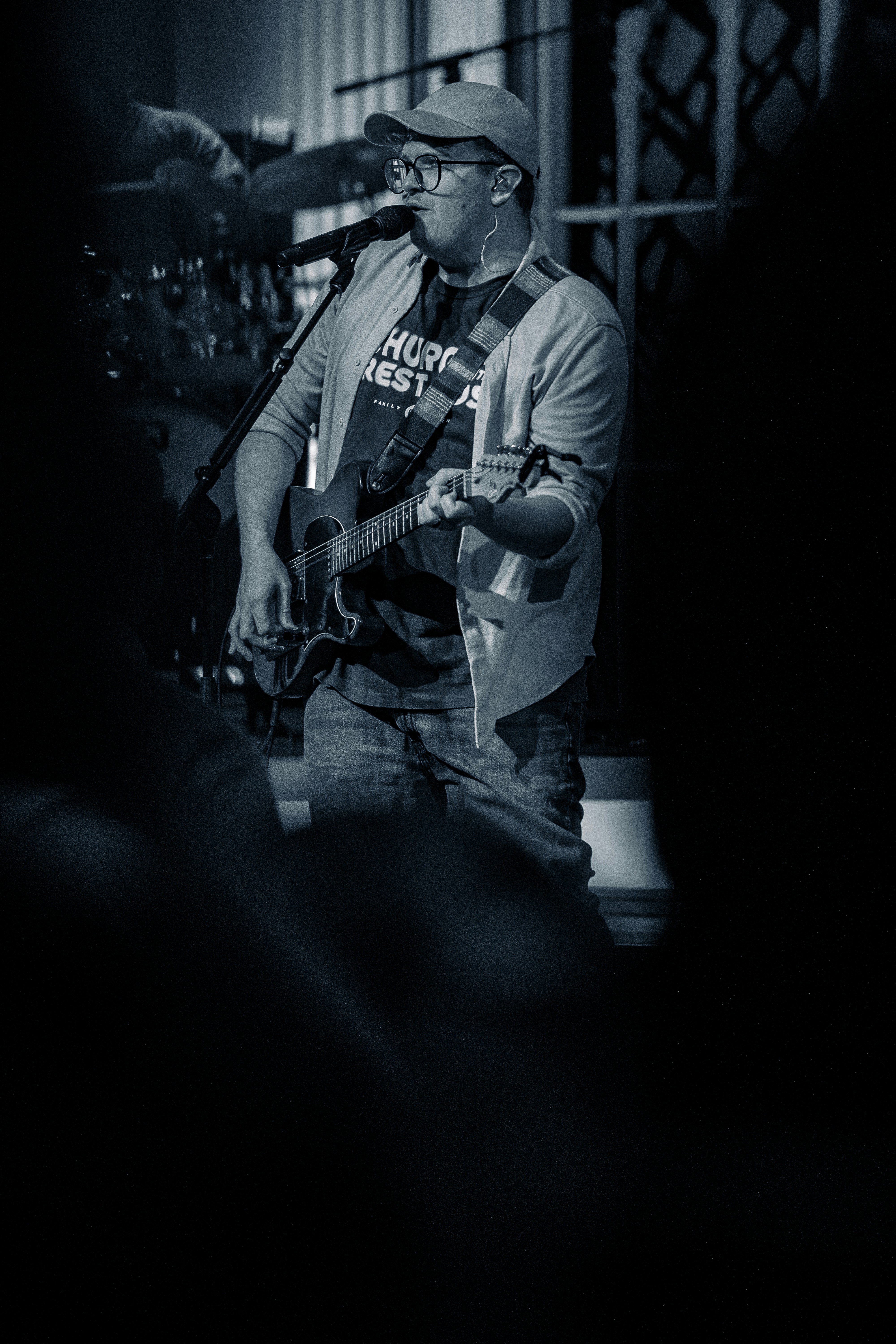 Man playing guitar and singing on stage