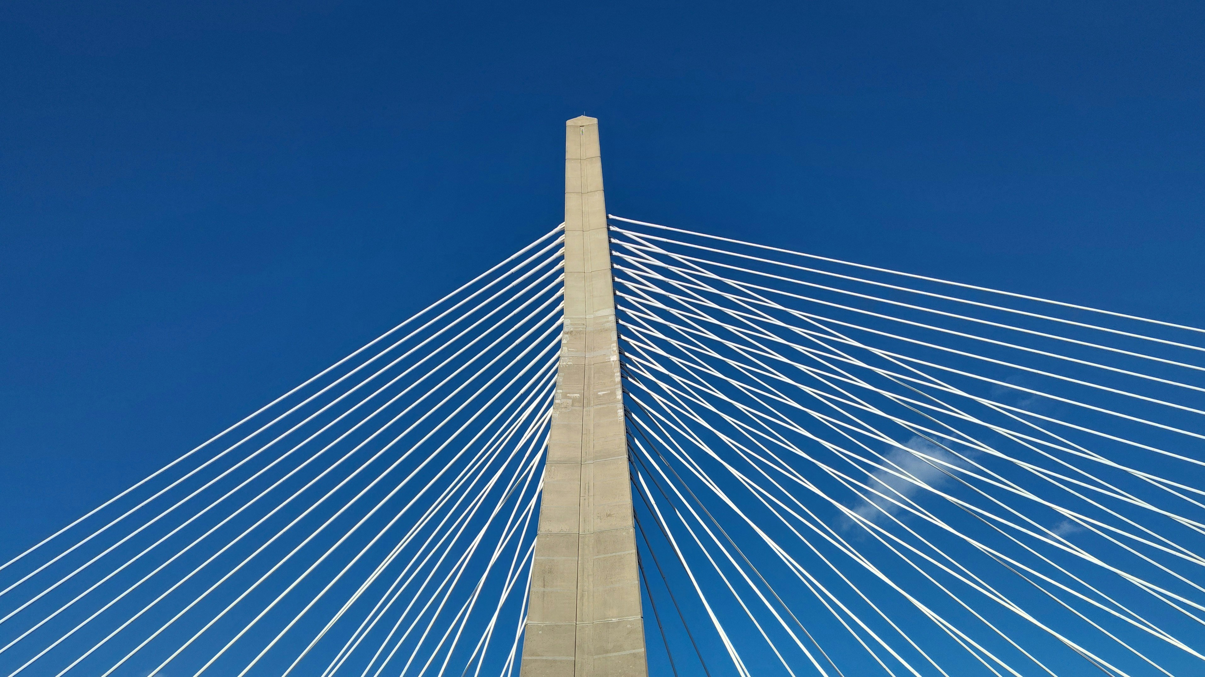 Concrete pylon with cables against blue sky