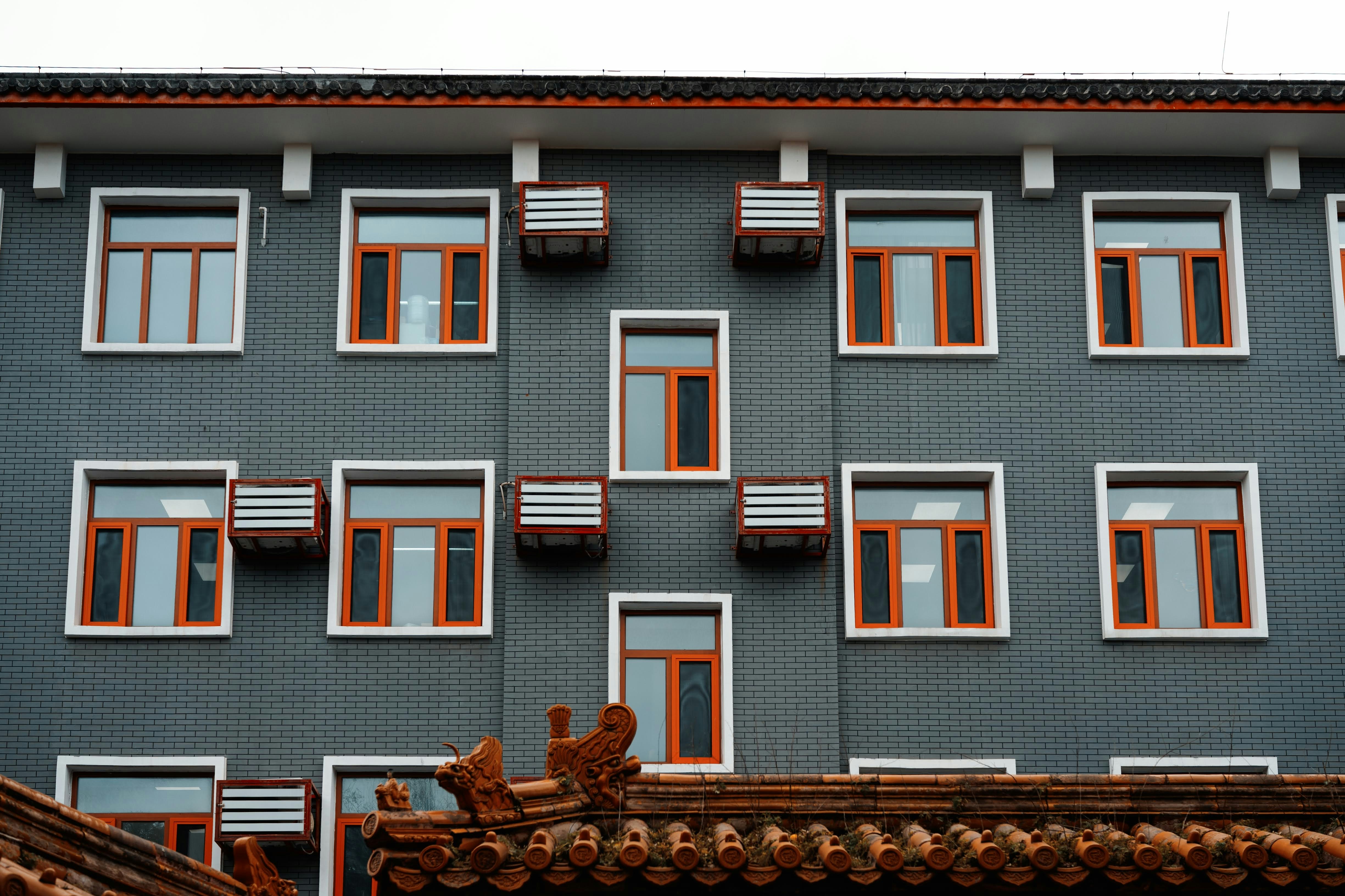 Modern building facade with repeating windows and ac units