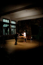 Two people setting up a product shoot indoors.