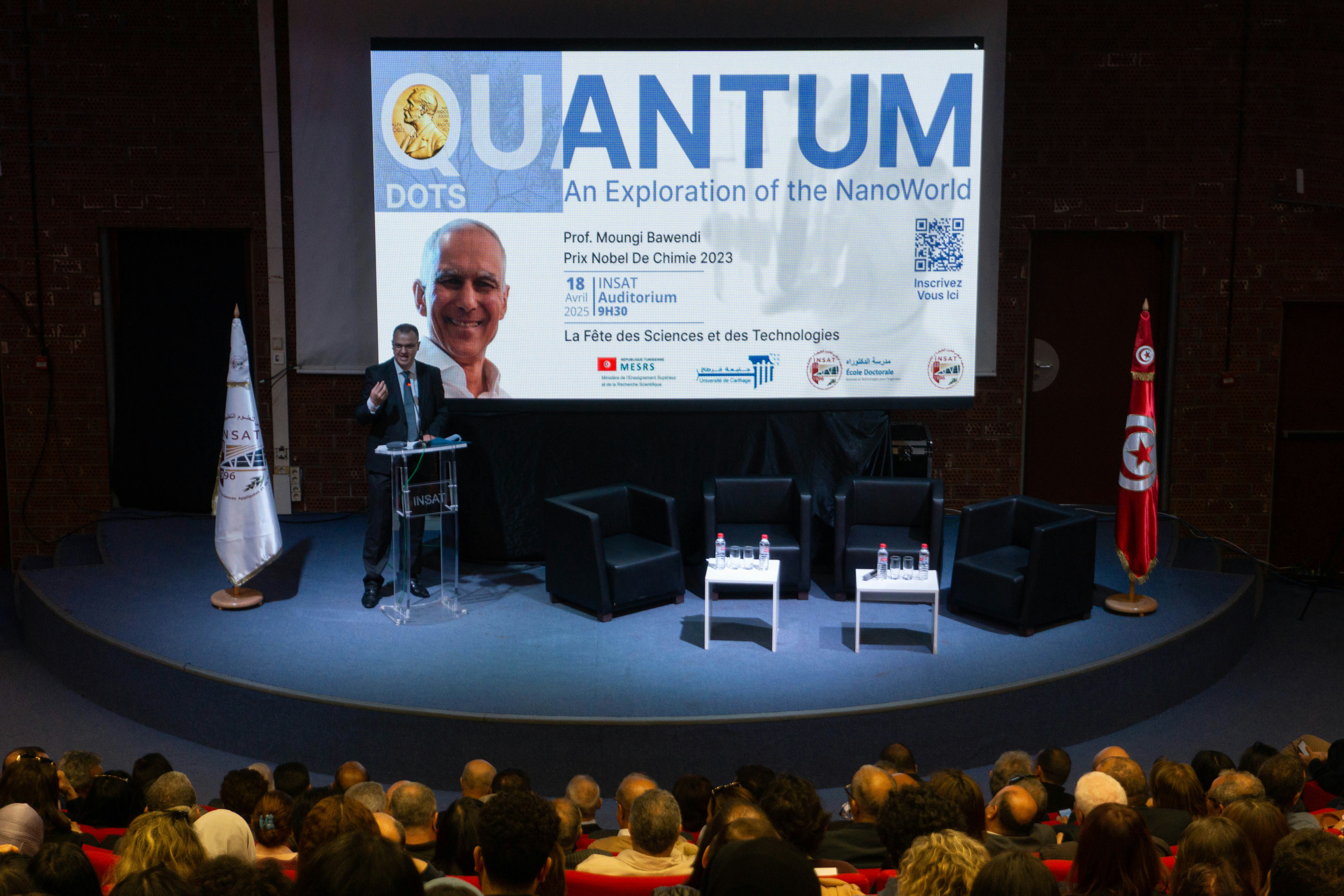 Speaker presents at quantum dots event on stage