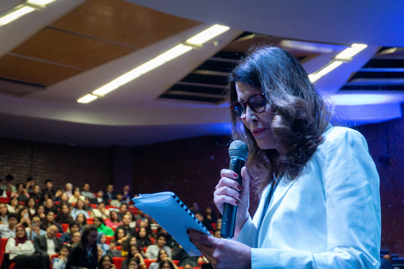 Confident woman speaker at a podium delivering a powerful keynote