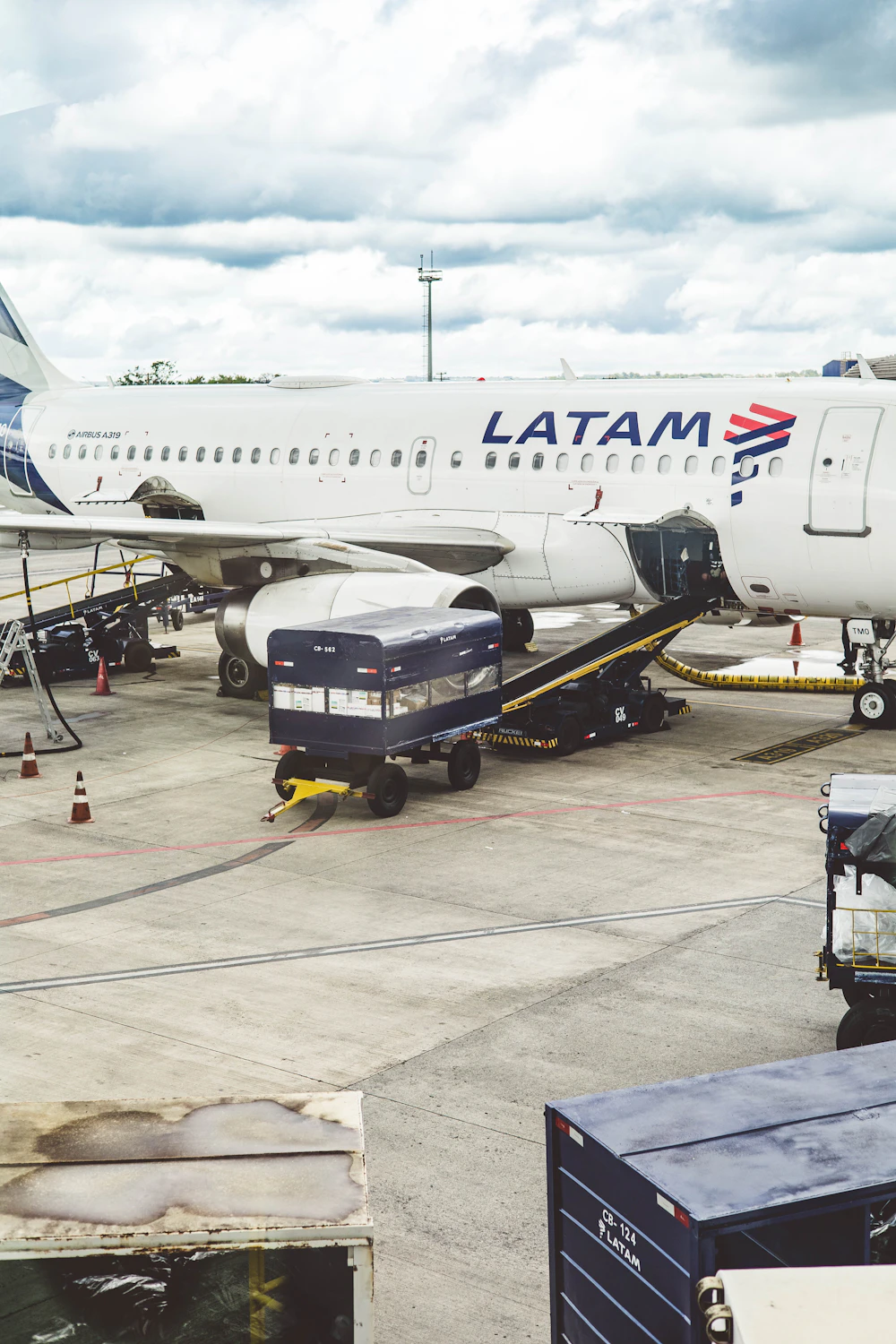Air cargo equipment loading freight beside a commercial aircraft
