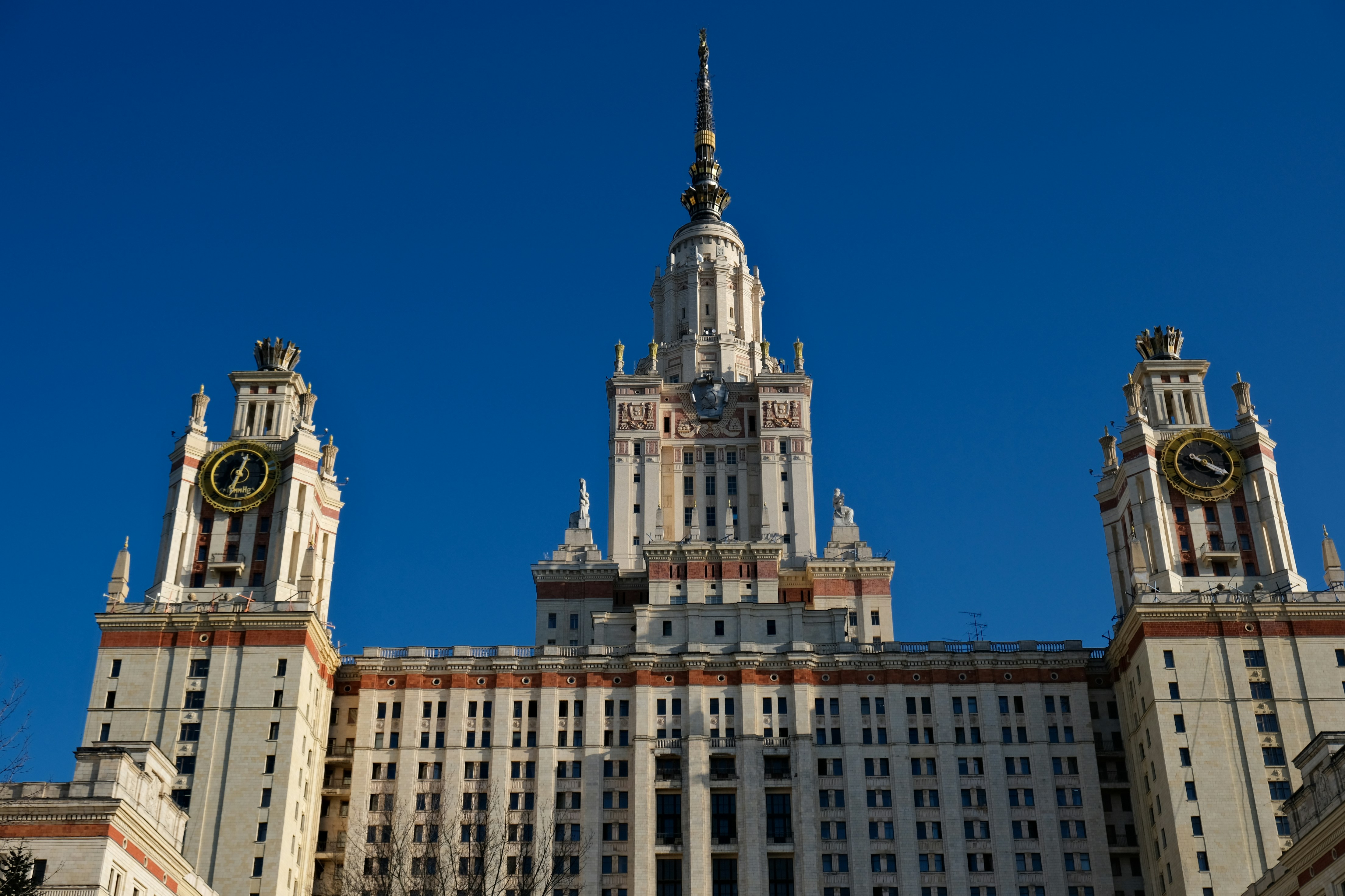 A grand stalinist skyscraper against a clear blue sky
