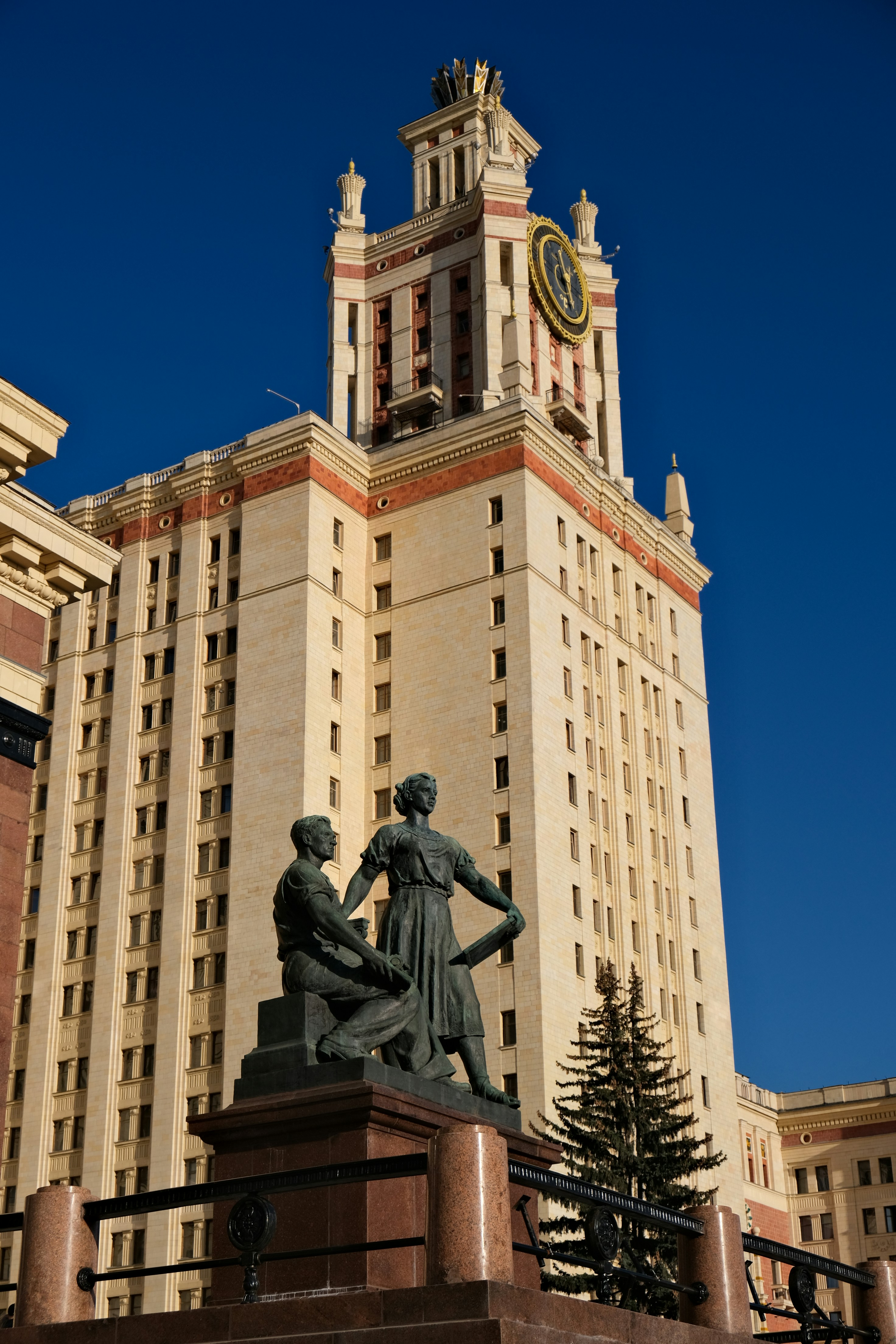 Tall building with a clock tower and statues