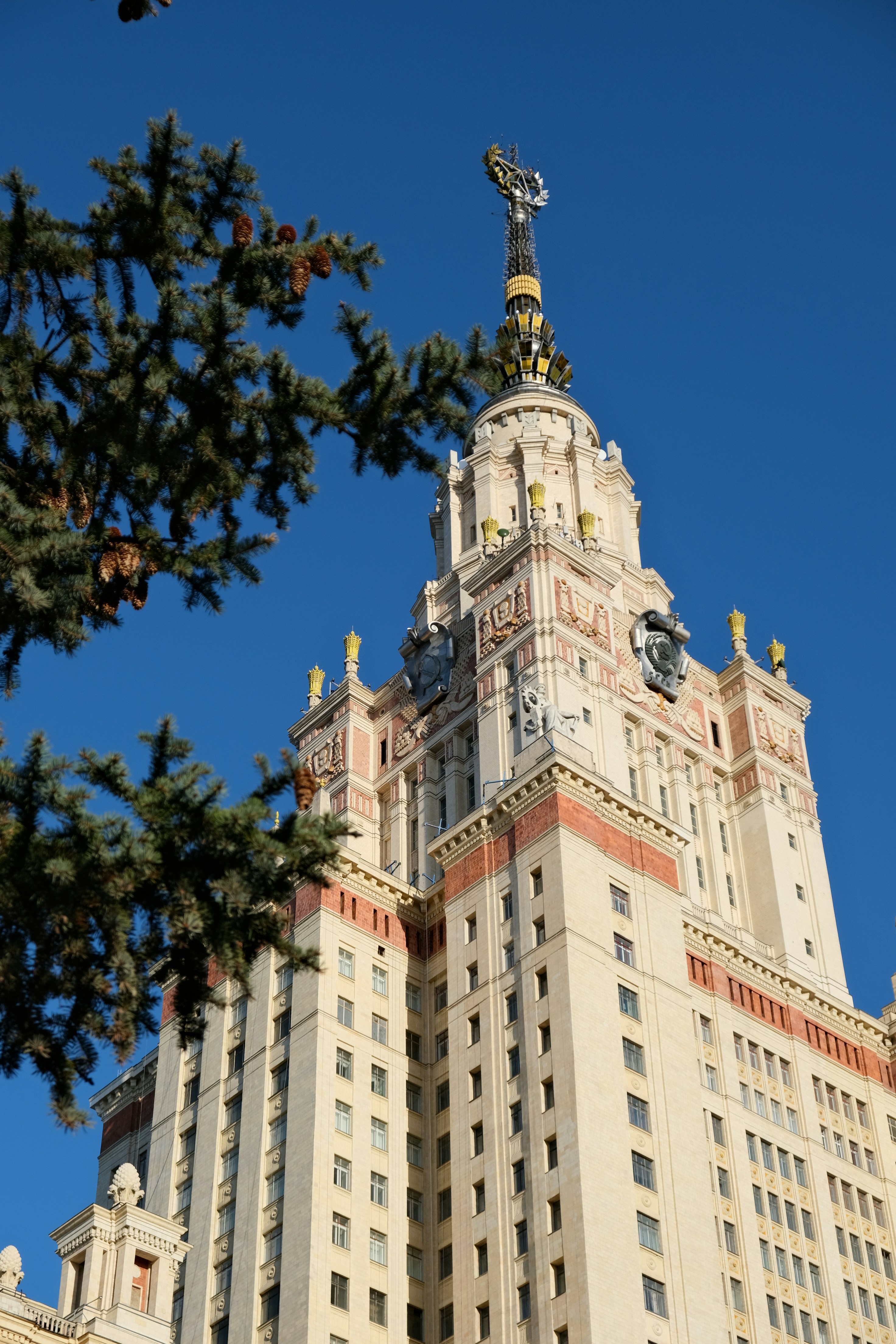 Tall ornate building with a spire against blue sky