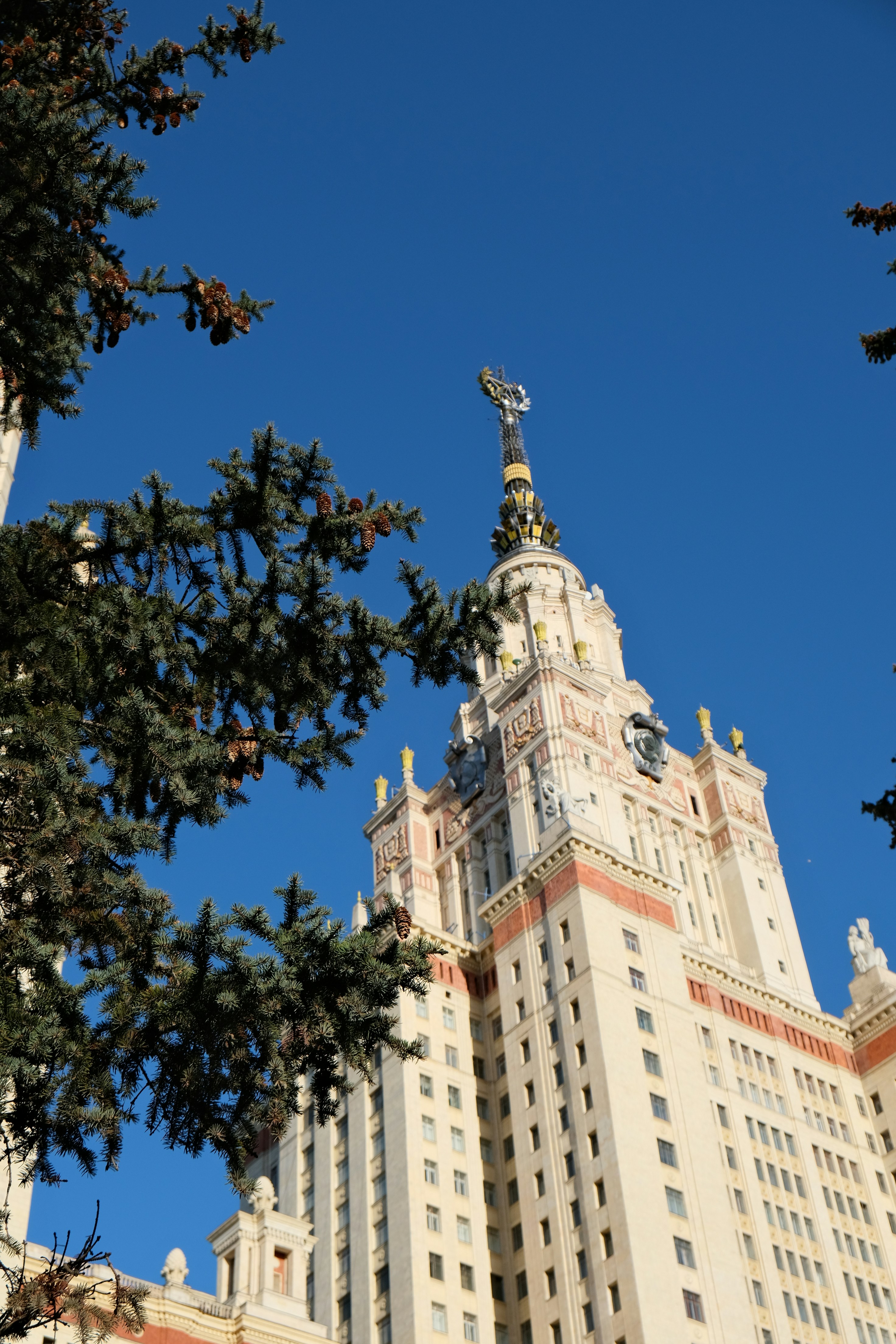 Tall building with ornate spire against blue sky.