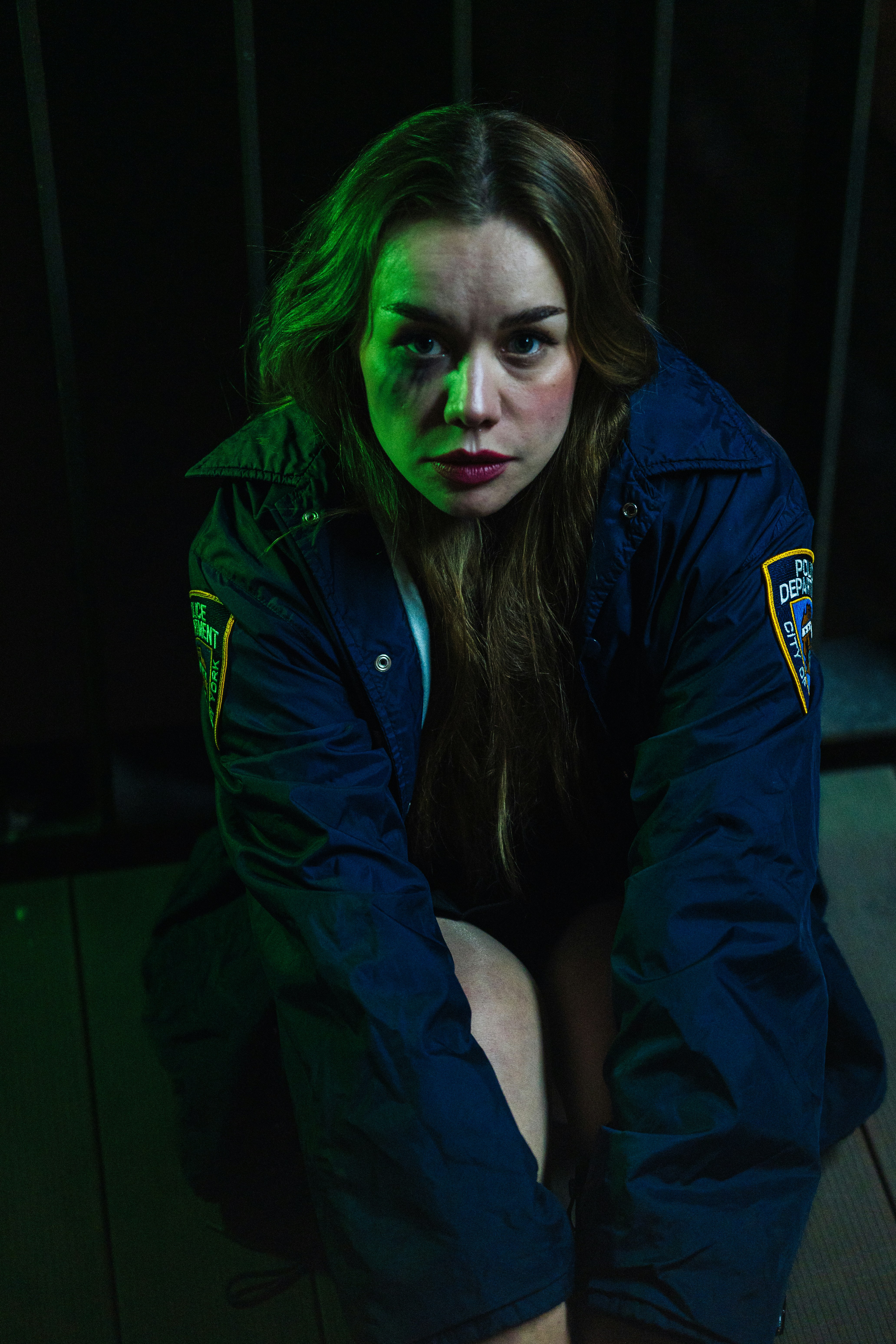 Woman in police jacket with bruise on face