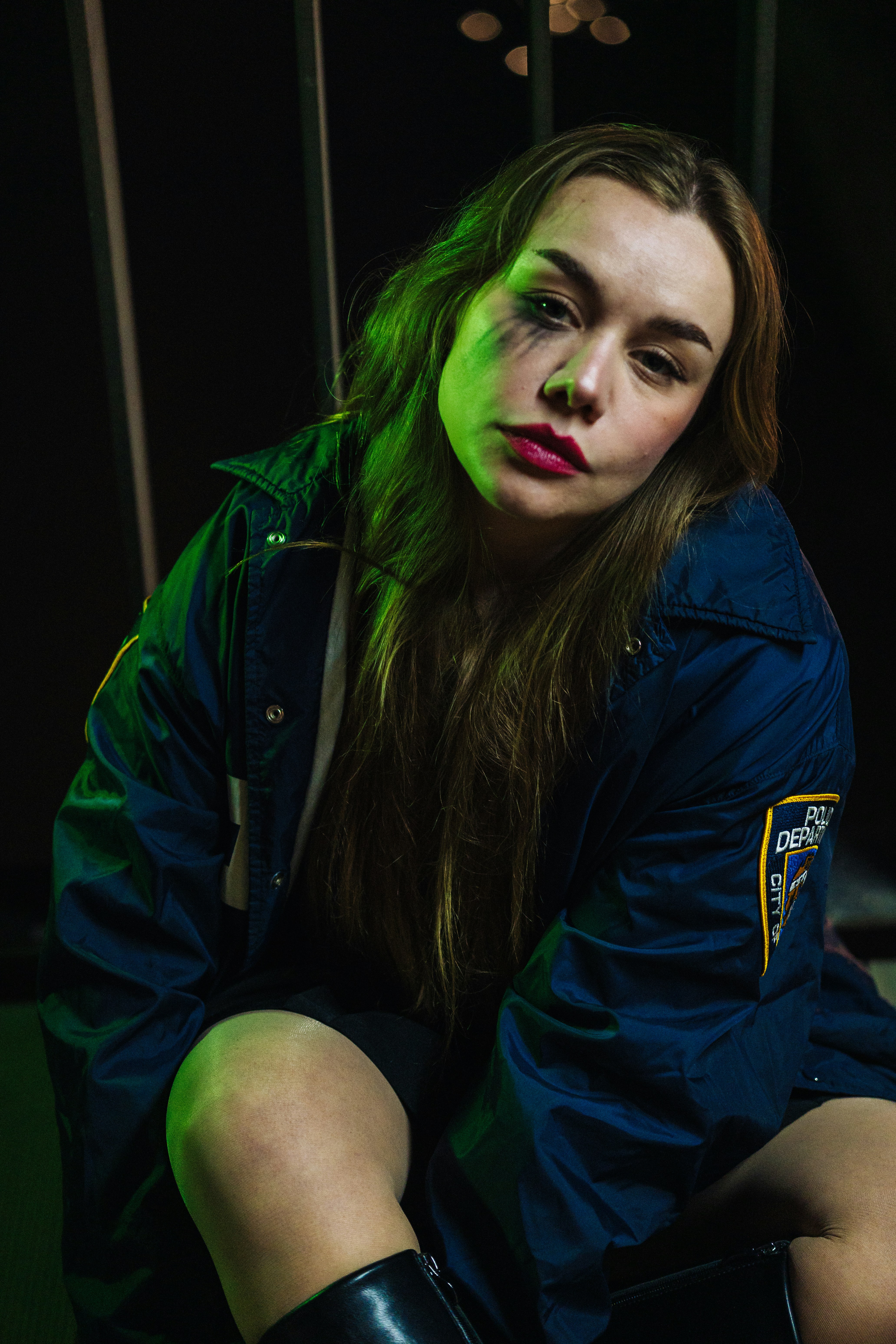 Woman in a police jacket with smudged makeup