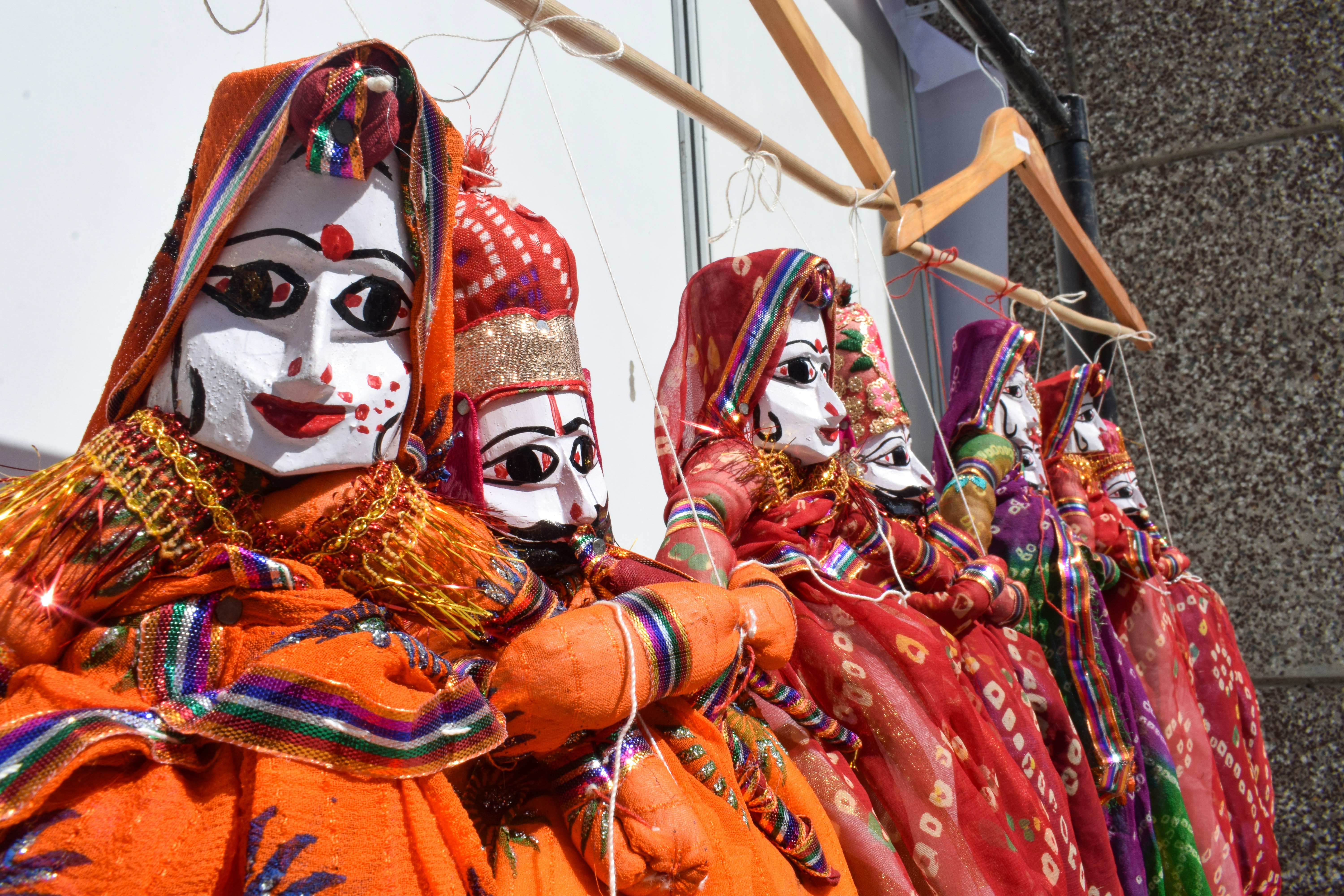Colorful traditional indian puppets displayed in a row