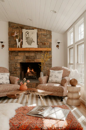 Cozy living room with stone fireplace and comfortable chairs