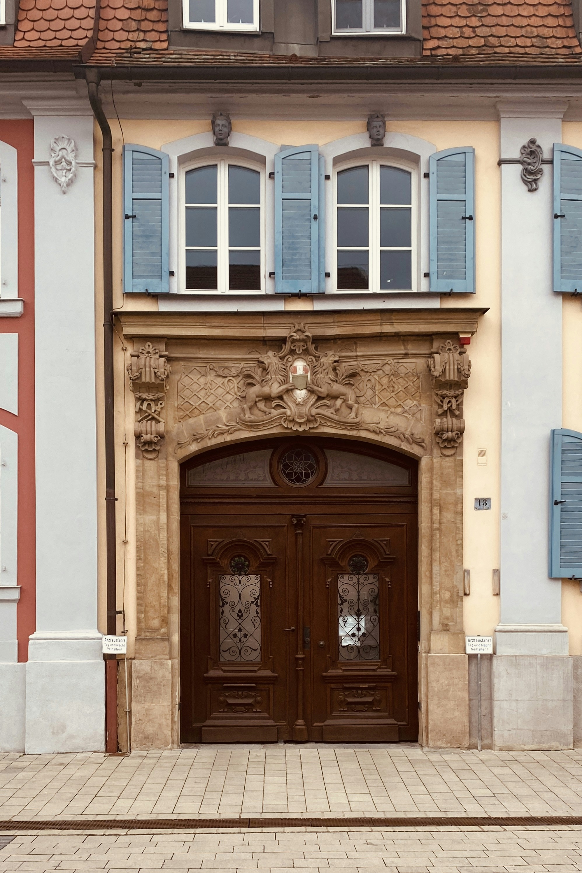 Ornate wooden doors beneath a decorative stone archway.