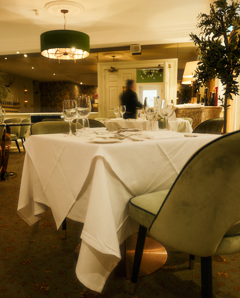 Formally set dining table with white linen