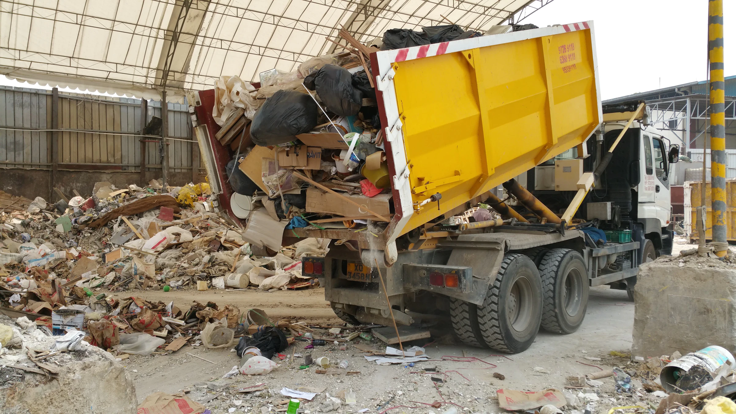 Debris hauling truck unloading a mixed cleanup load
