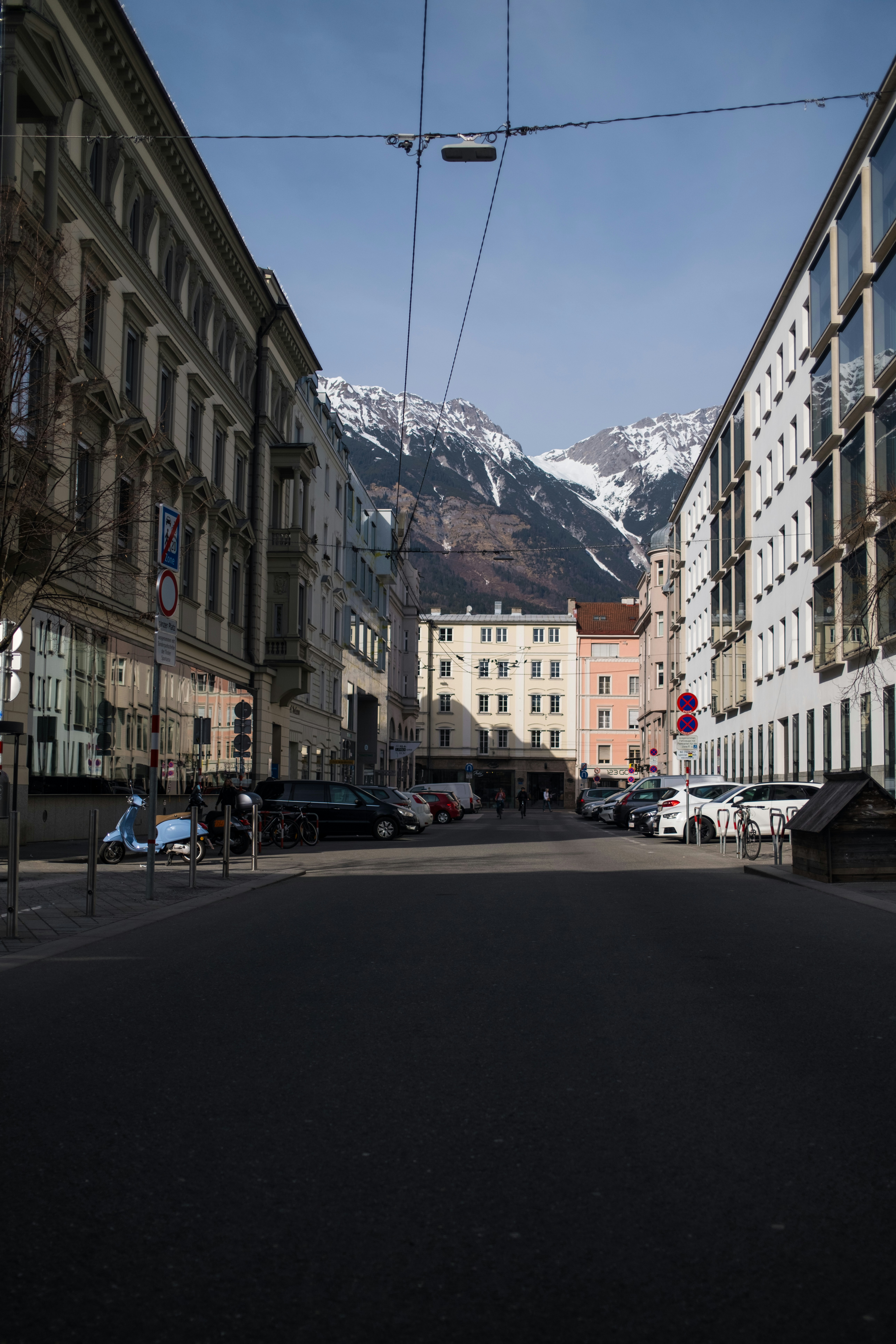 Street view with buildings and snow-capped mountains in background