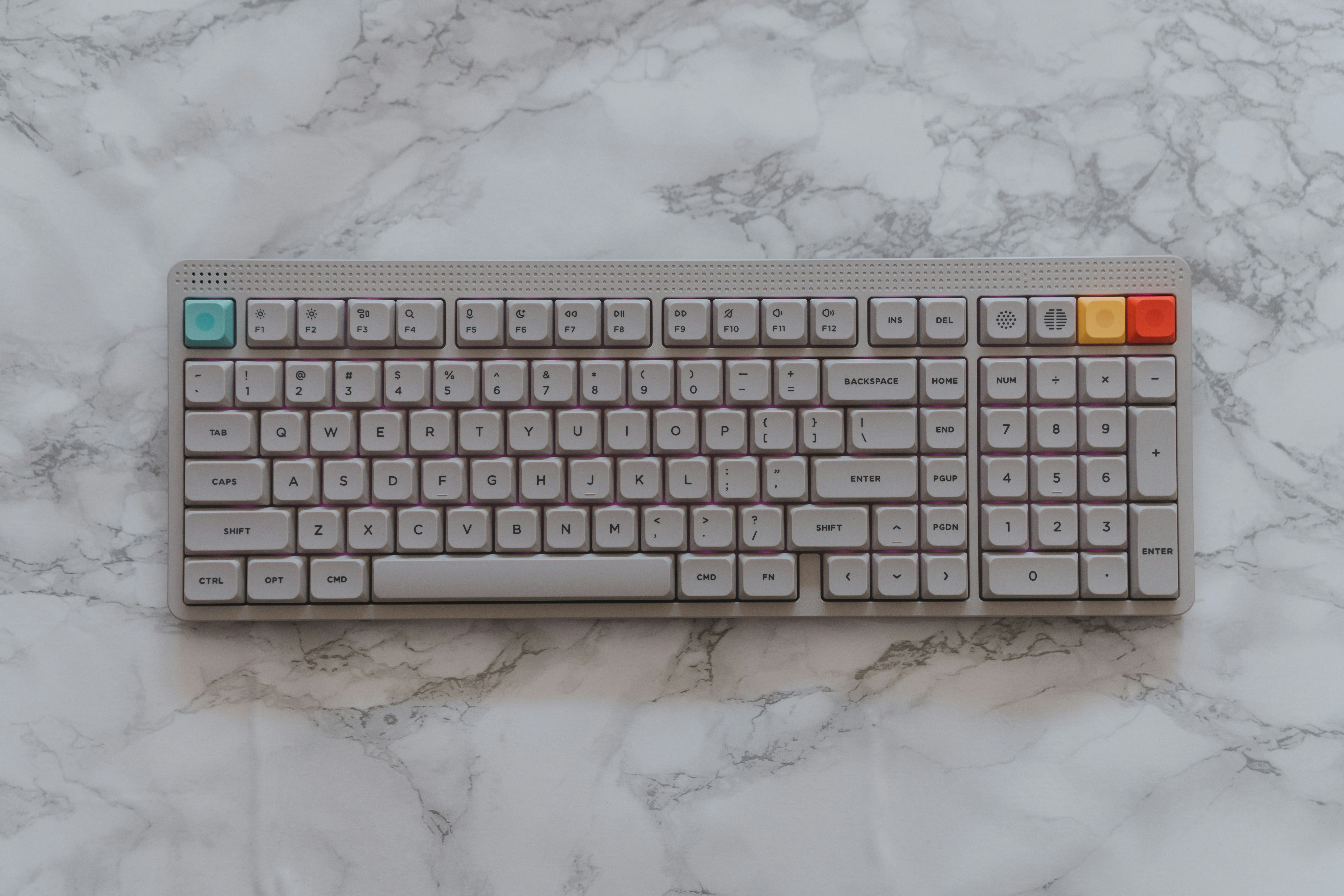 A gray mechanical keyboard on a marble surface.