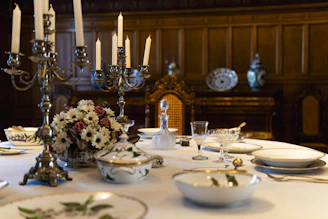 Elegant dining table set with fine china and candles