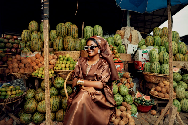 West African woman surrounded by abundant market produce
