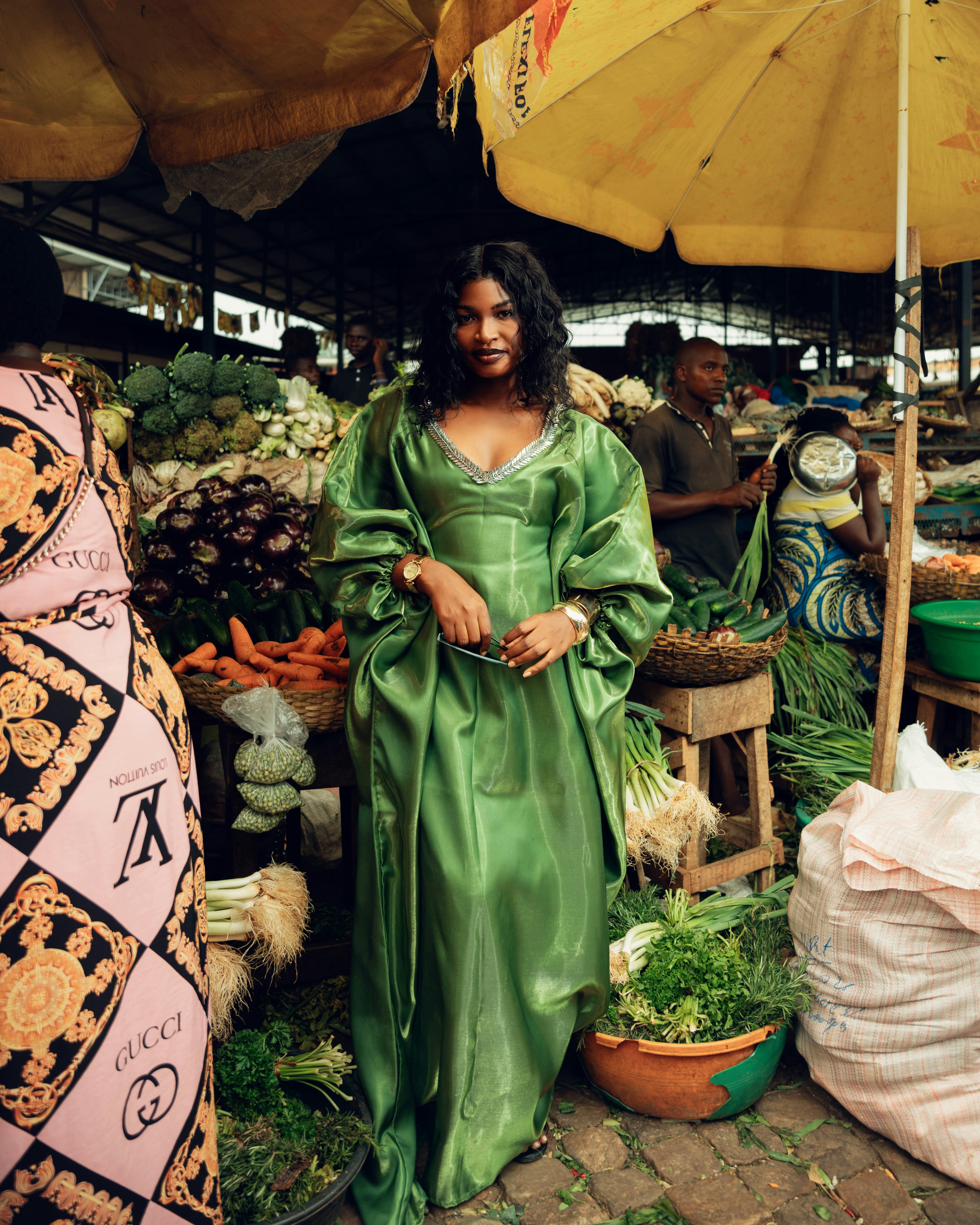 Busy open-air market street with vendors and shoppers in a Kenyan town