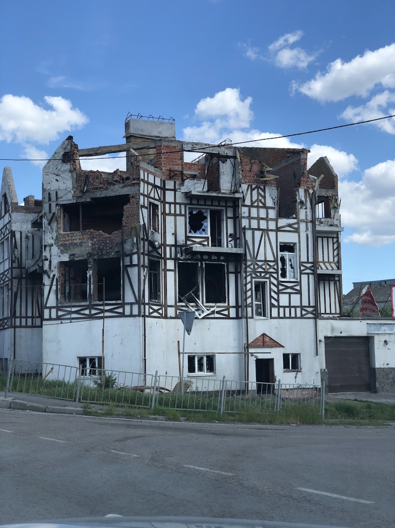 Damaged building with broken windows and exposed brick