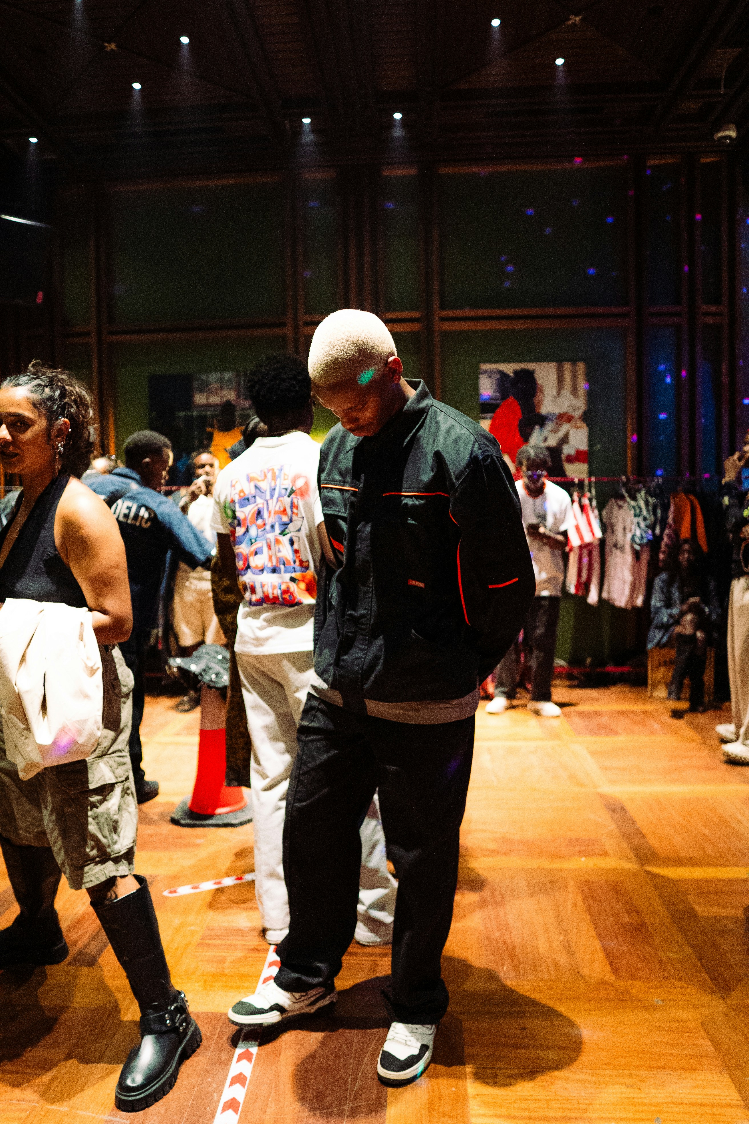 People gathered in a room with wooden floors