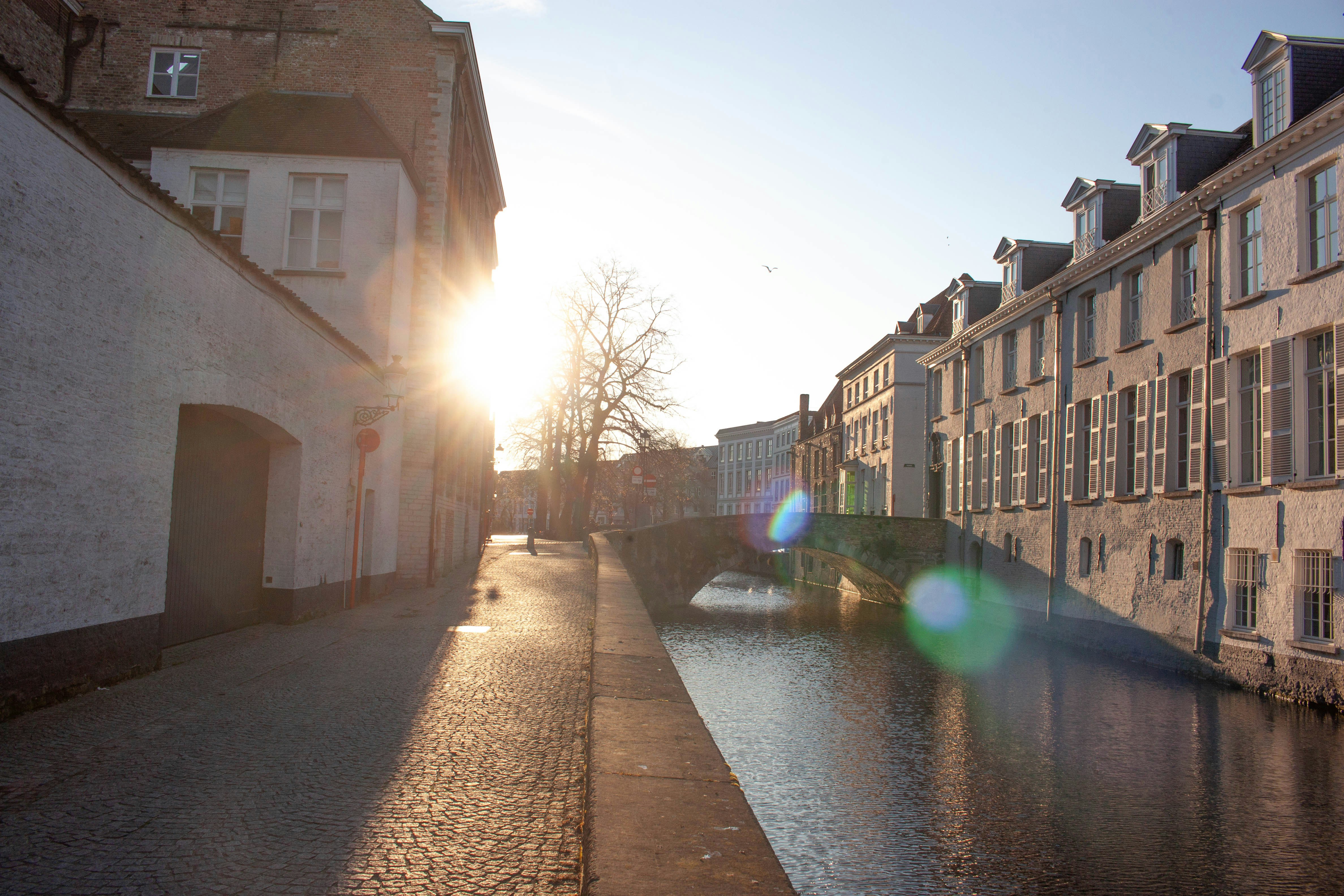 Sunlight shines on a canal and buildings