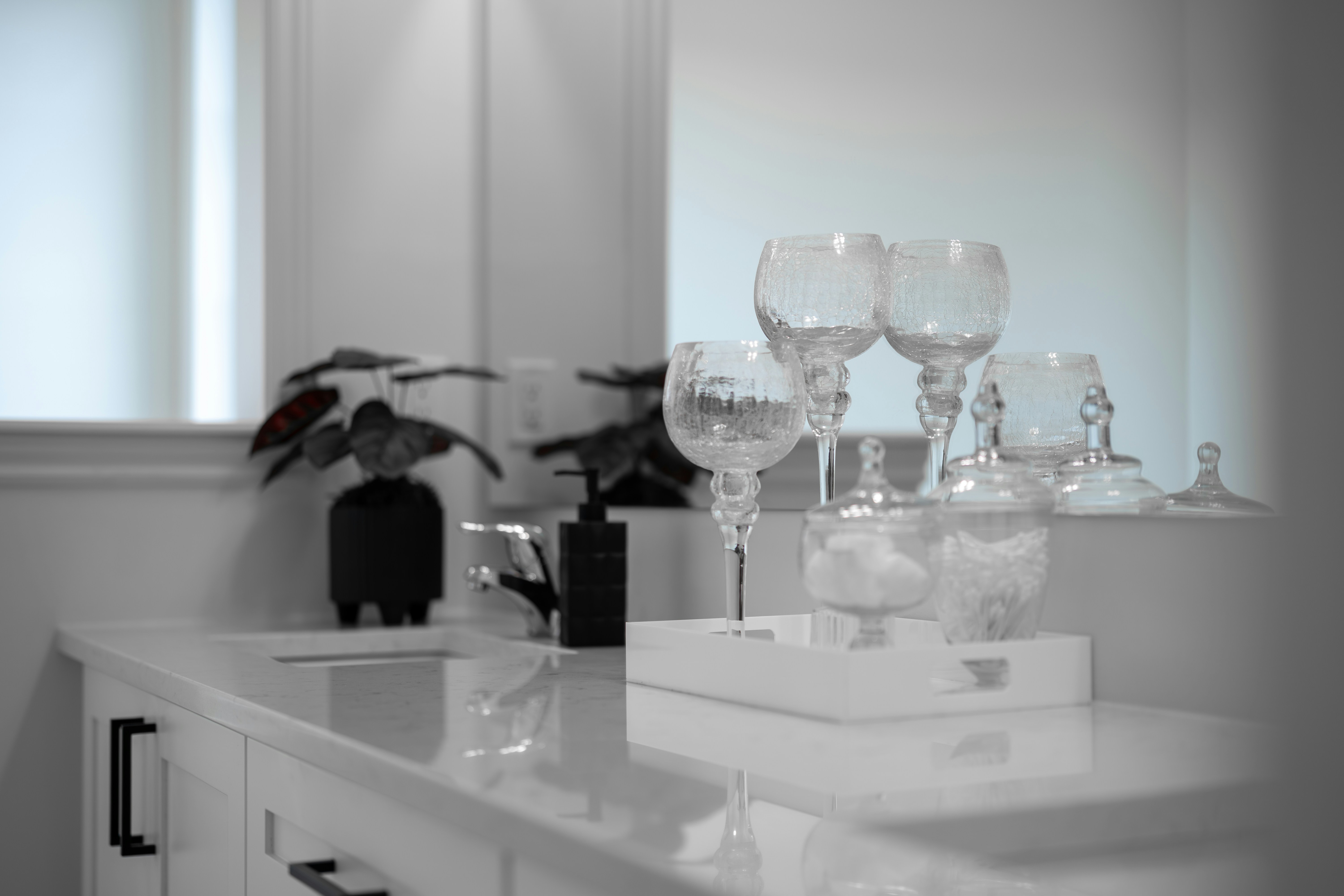 Clear wine glasses on a white counter