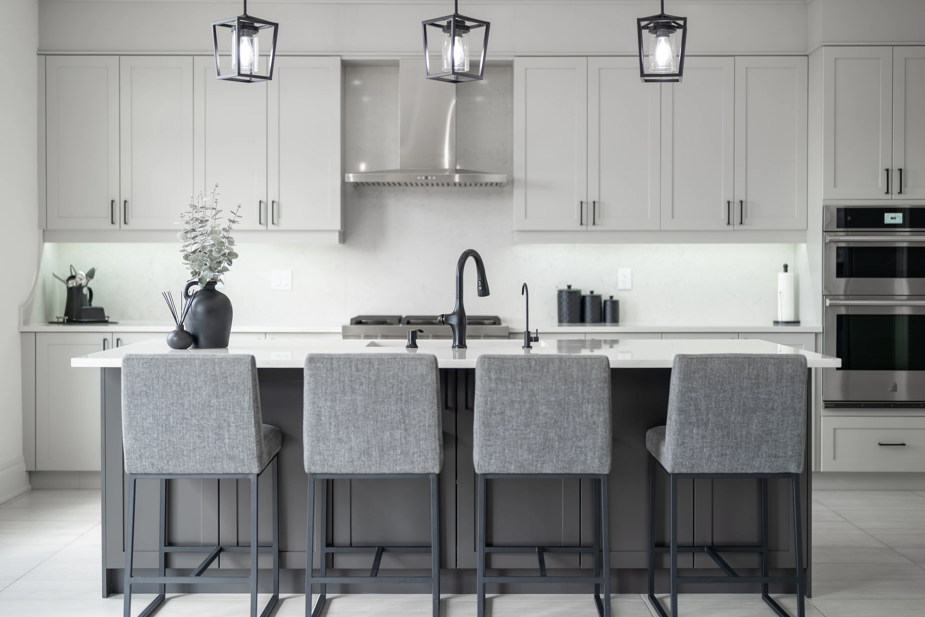 Kitchen island with four grey bar stools